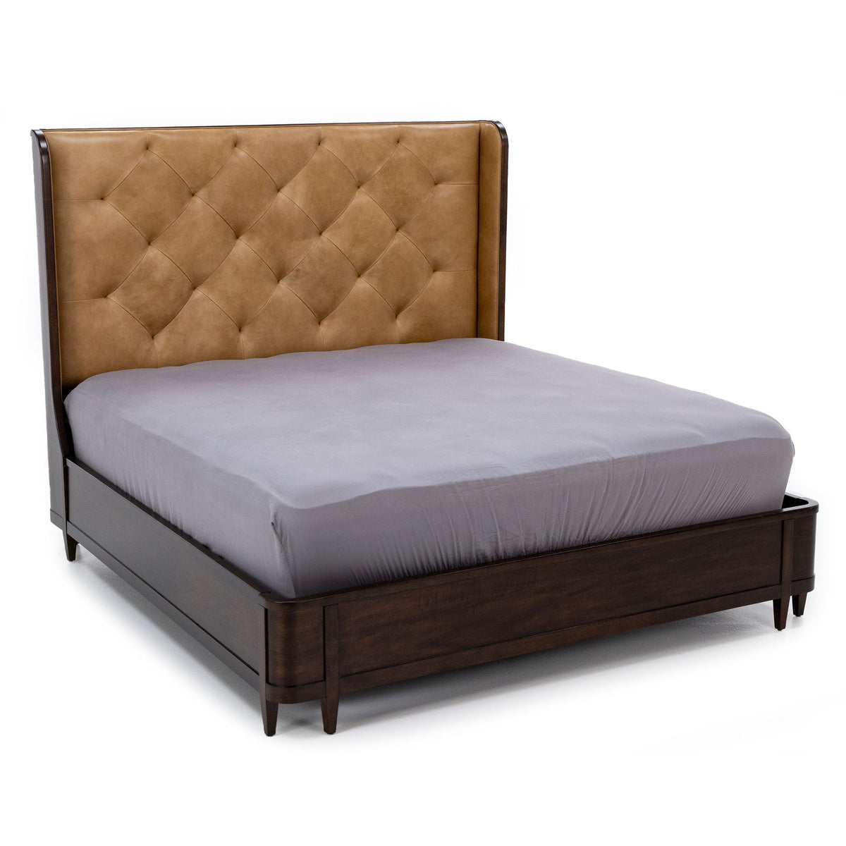 Upholstered bed with tufted tan headboard and dark wood frame.
