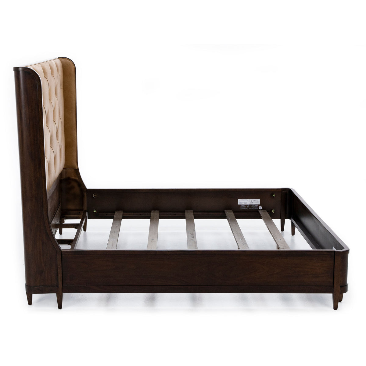 Wood bed frame with tan tufted headboard, shown without mattress.
