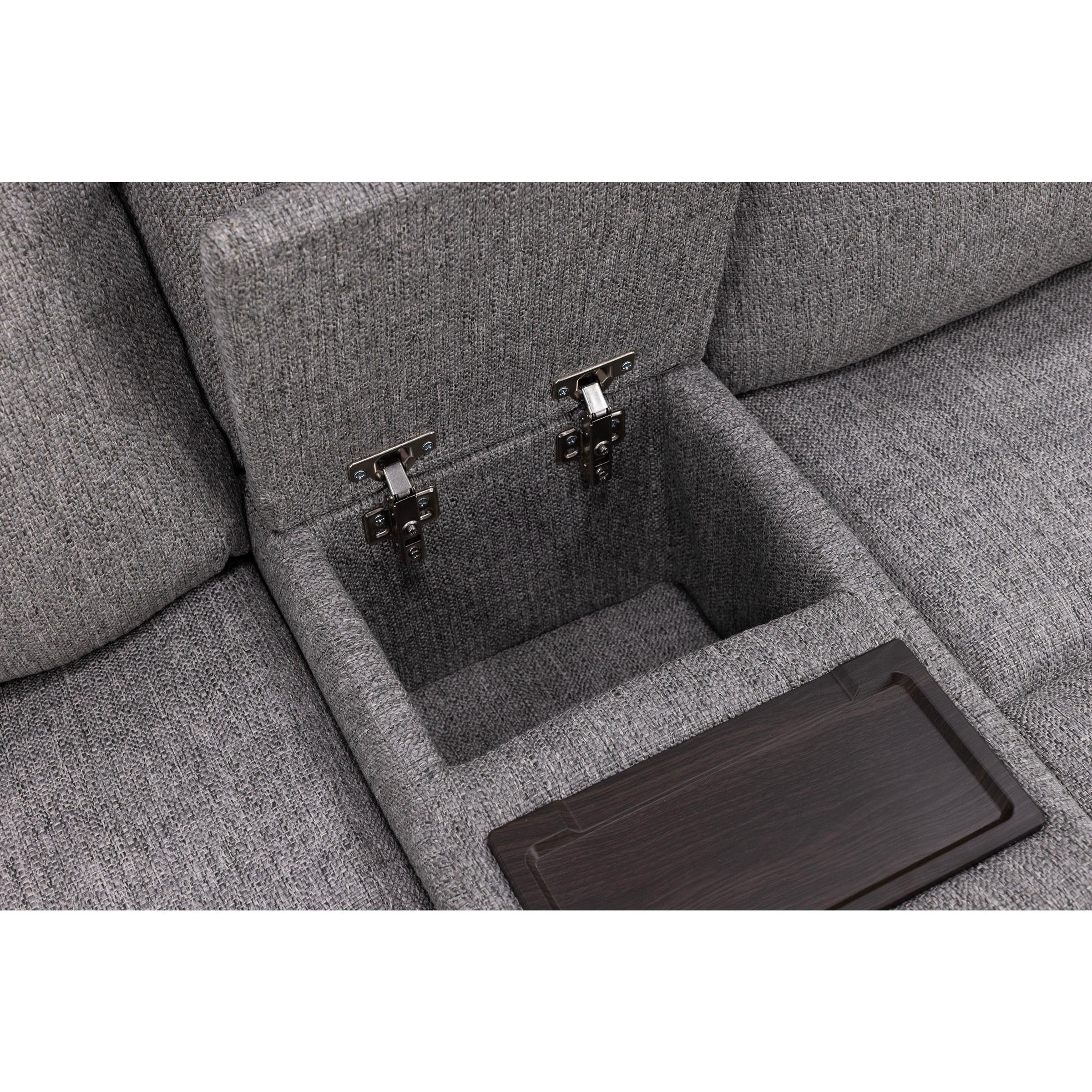 Open storage compartment in a gray fabric sofa with metal hinges and a wooden tray.