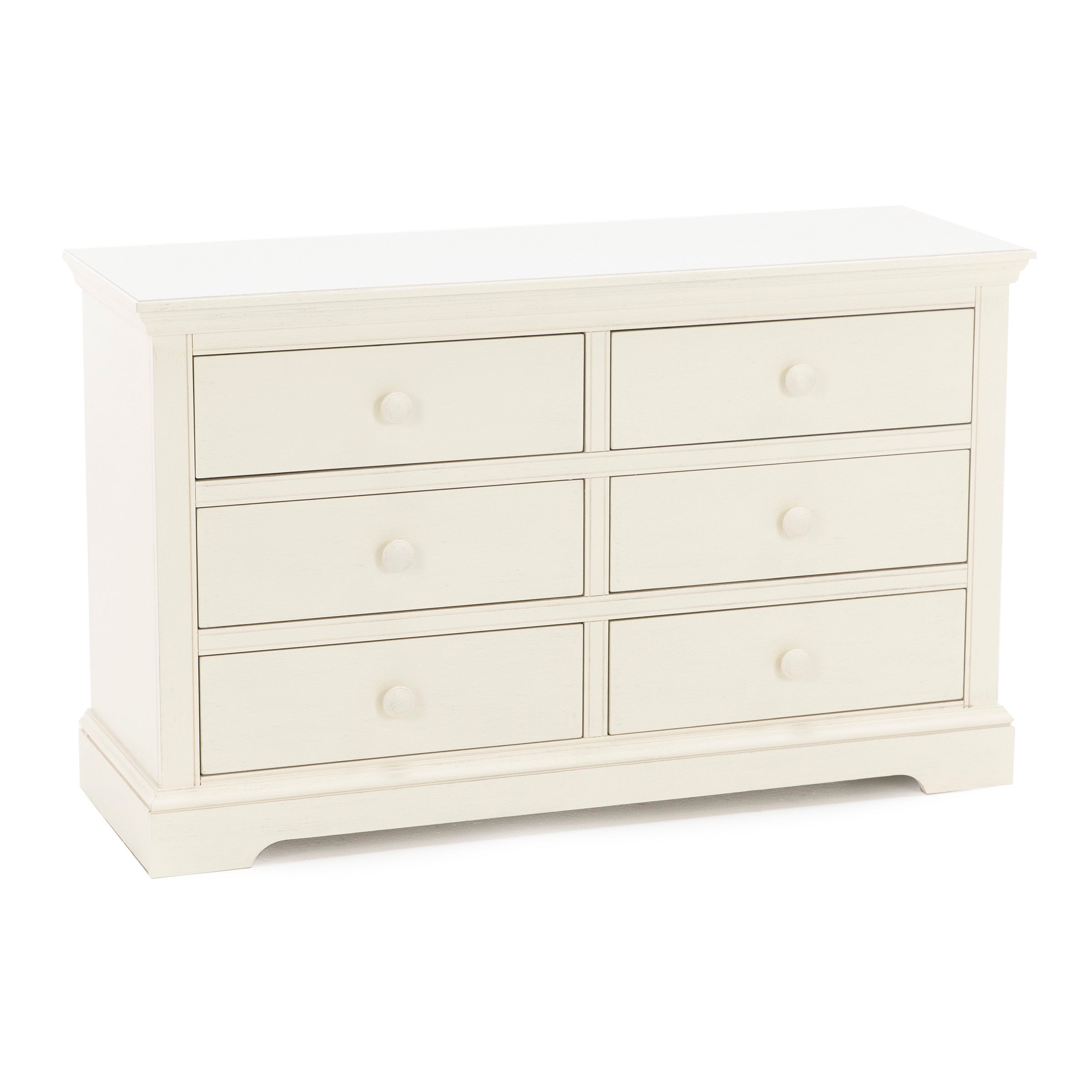 A white six-drawer dresser with round knobs and a simple, classic design.