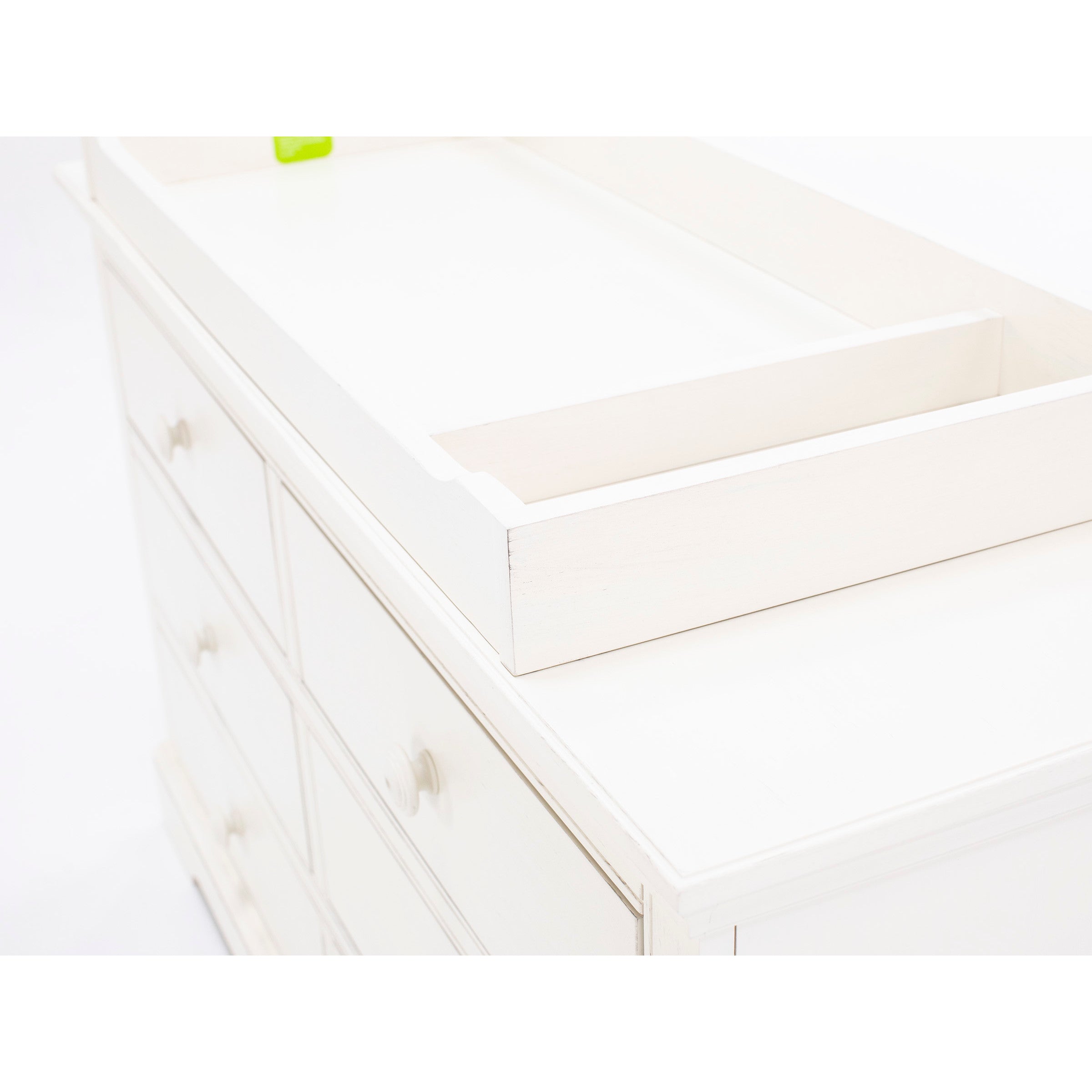 White wooden dresser with built-in changing tray on top.