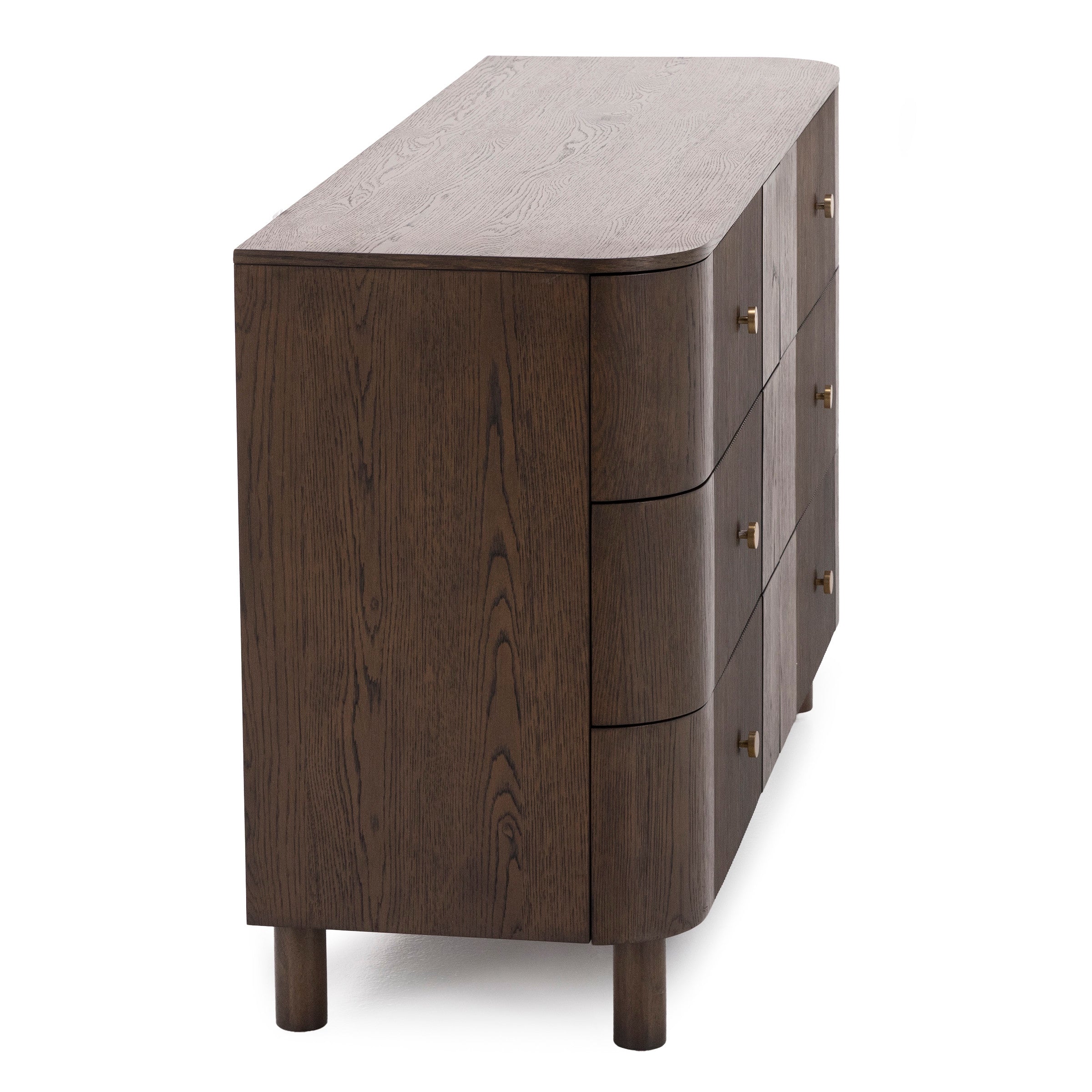Angled side view of a modern dark wood dresser with rounded corners and brass drawer pulls.