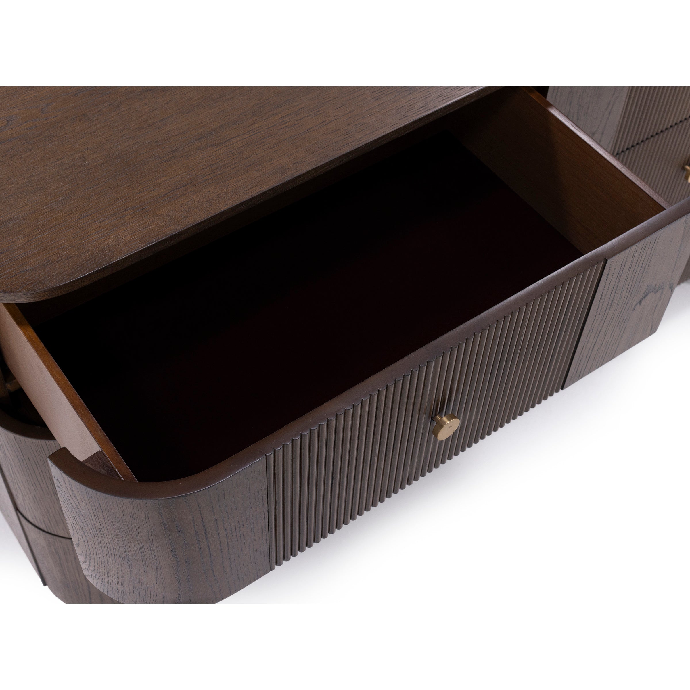 Open wooden drawer with gold knob, showing inside storage space.