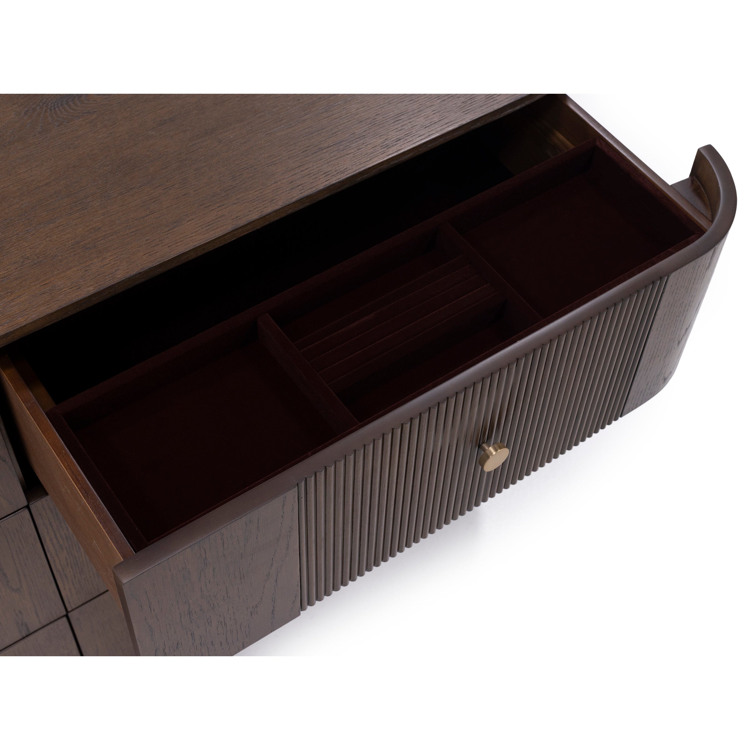Open wood drawer with organizer compartments and brass knob.