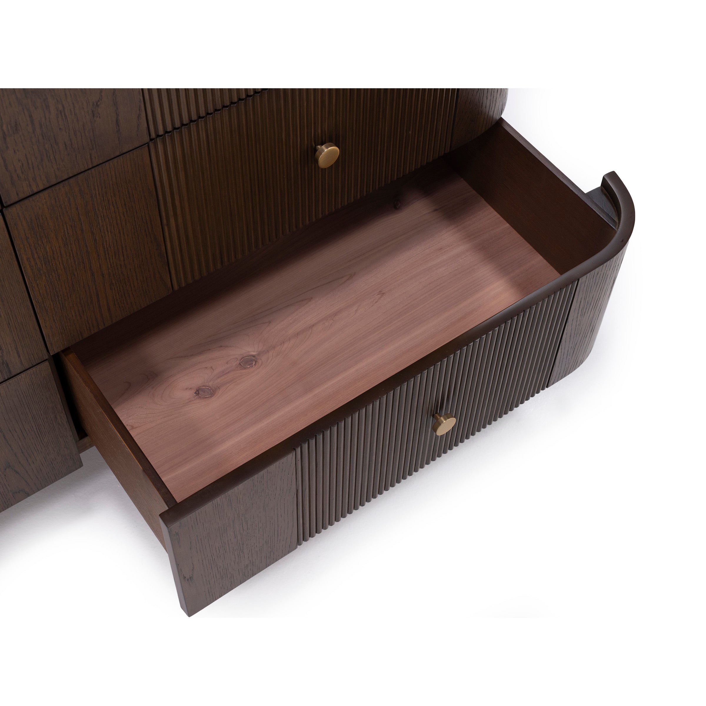 Open wooden drawer with a brass knob, part of a dark brown dresser.
