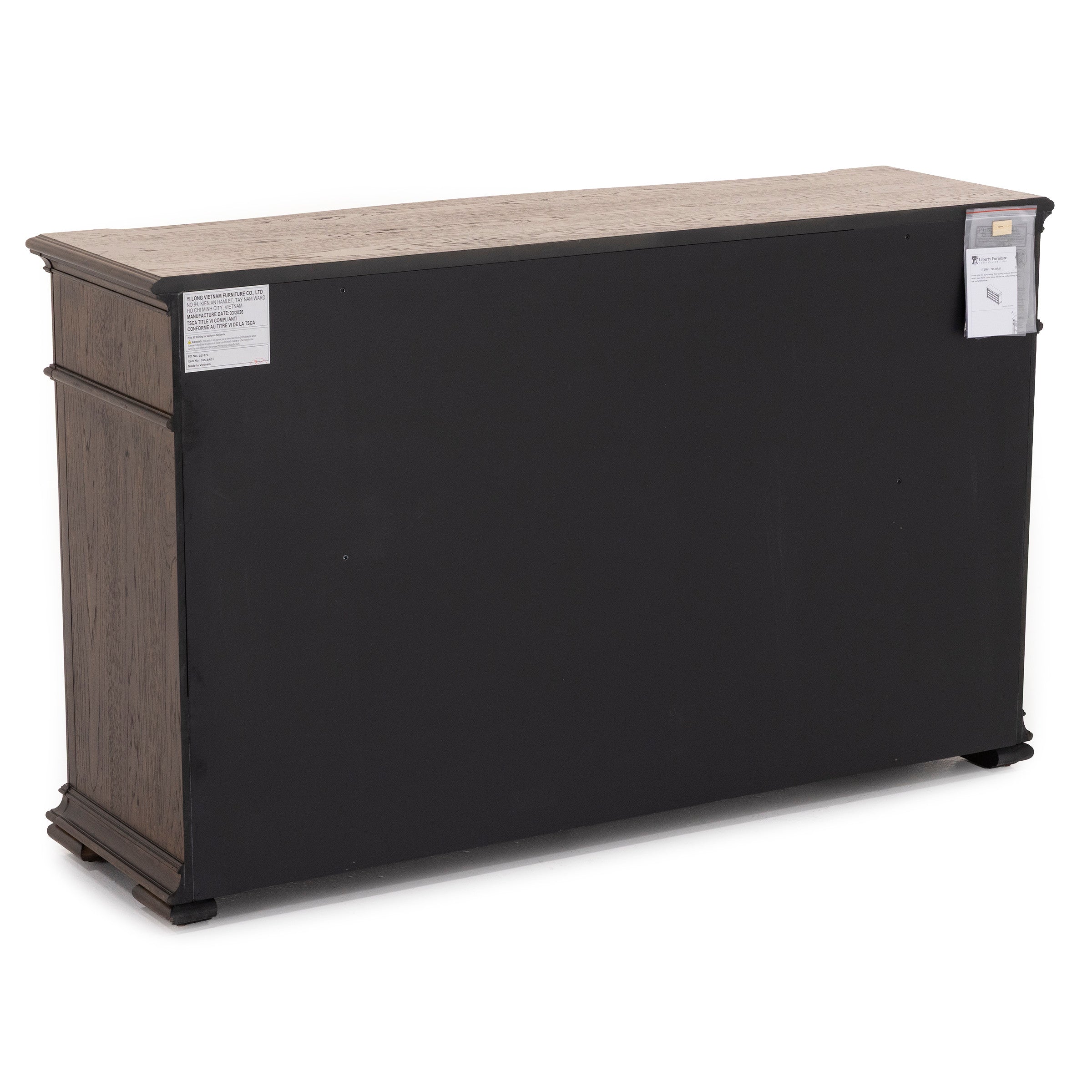 Back view of a wooden cabinet with a black panel and product labels.