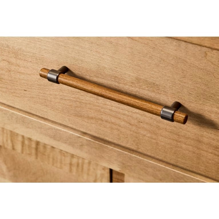 Close-up of a wooden drawer handle on a wood cabinet.