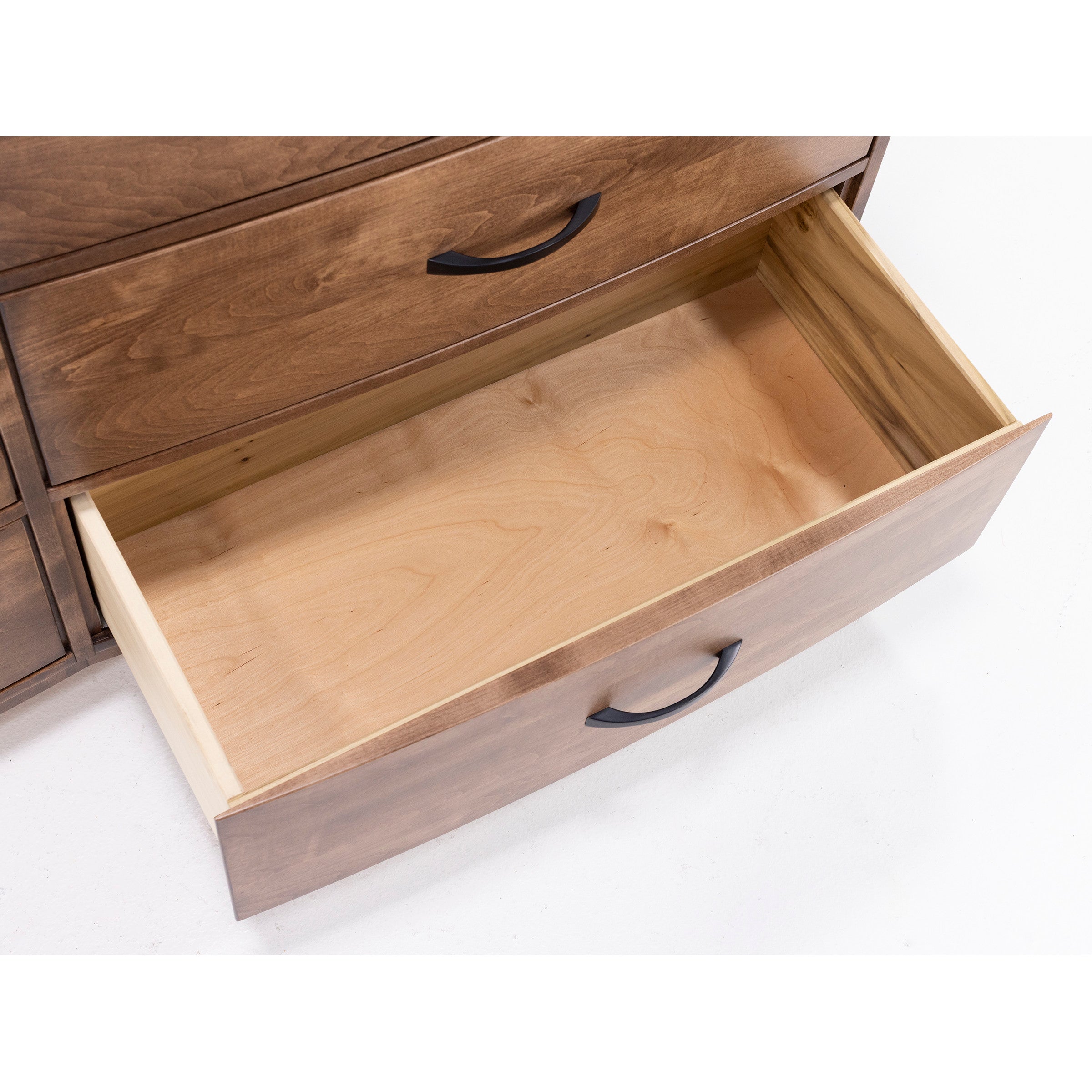 Open, empty wooden drawer with black handle.