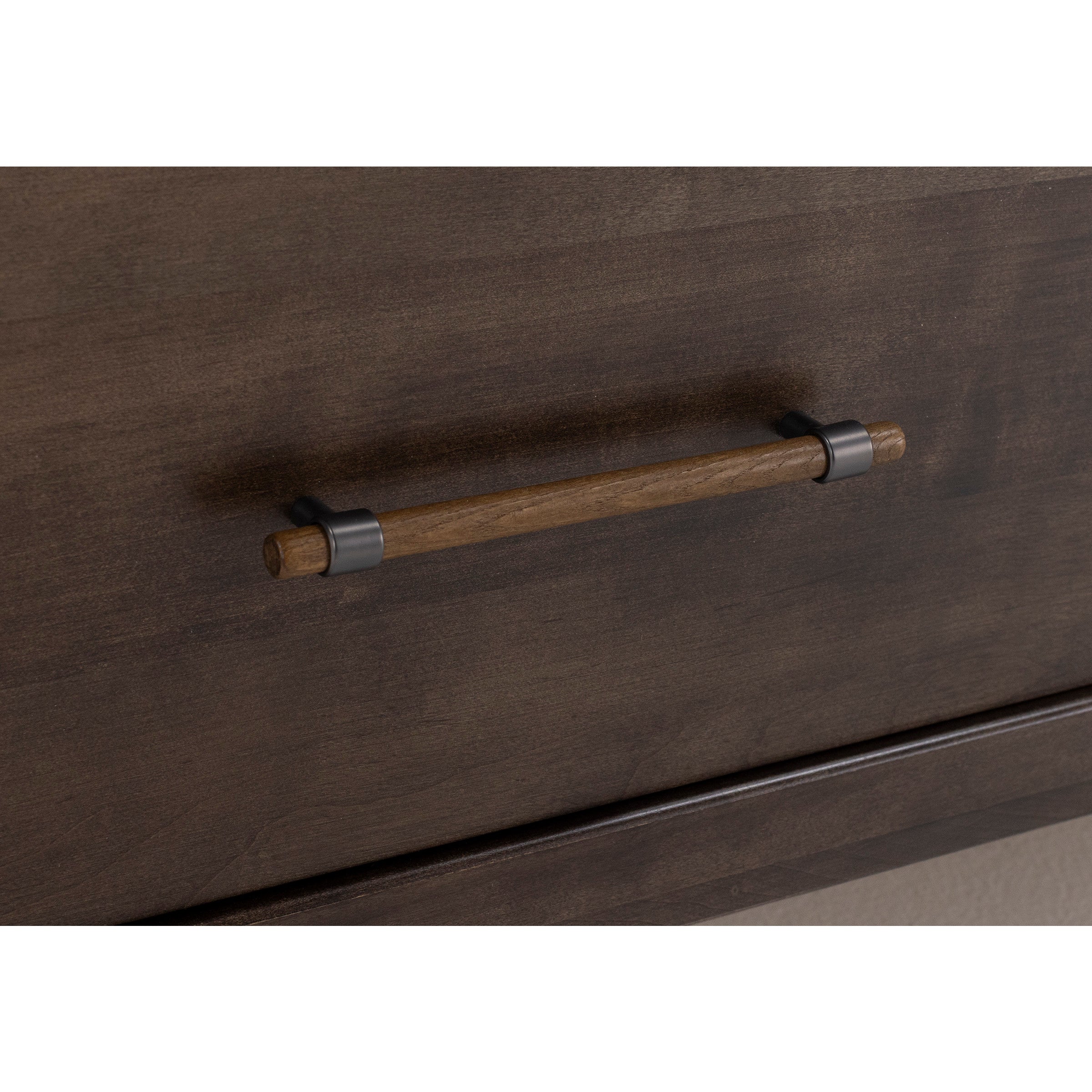 Close-up of a wooden drawer handle with metal brackets on a dark wood surface.