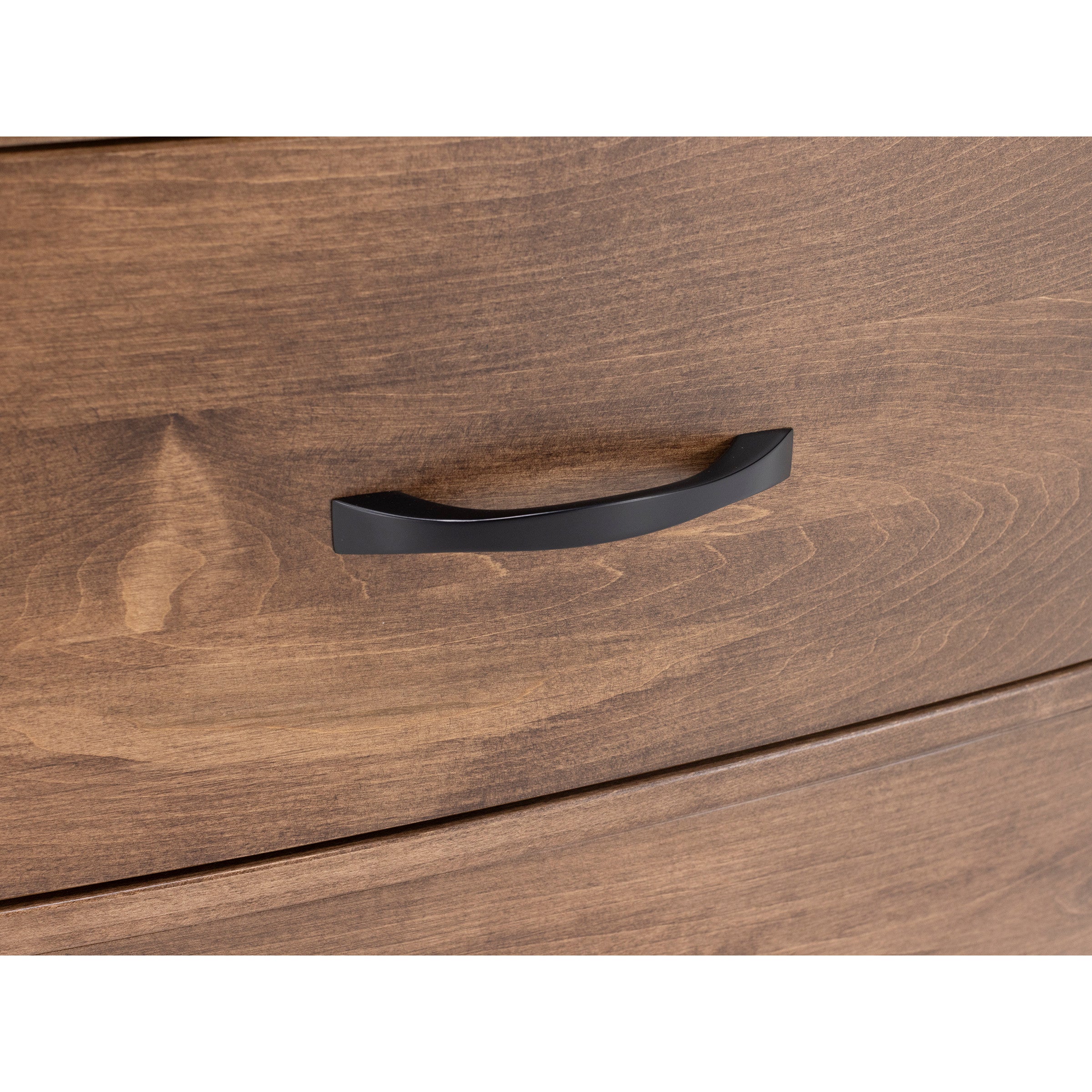 Close-up of a wood drawer with a black handle.