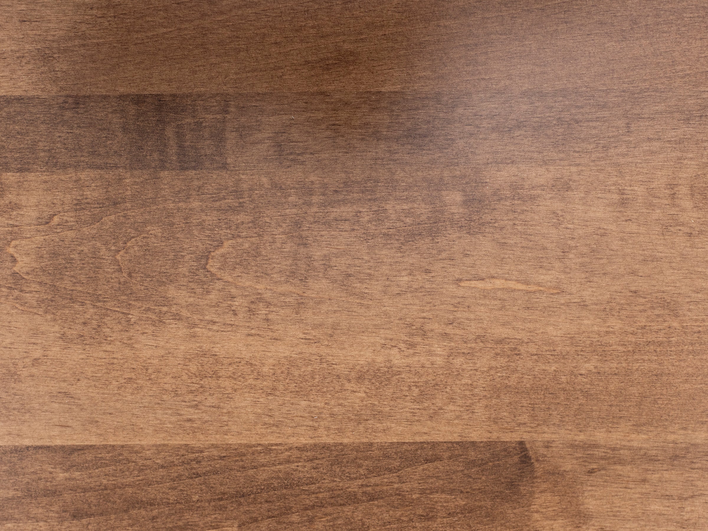 Light brown wooden surface with natural grain patterns.