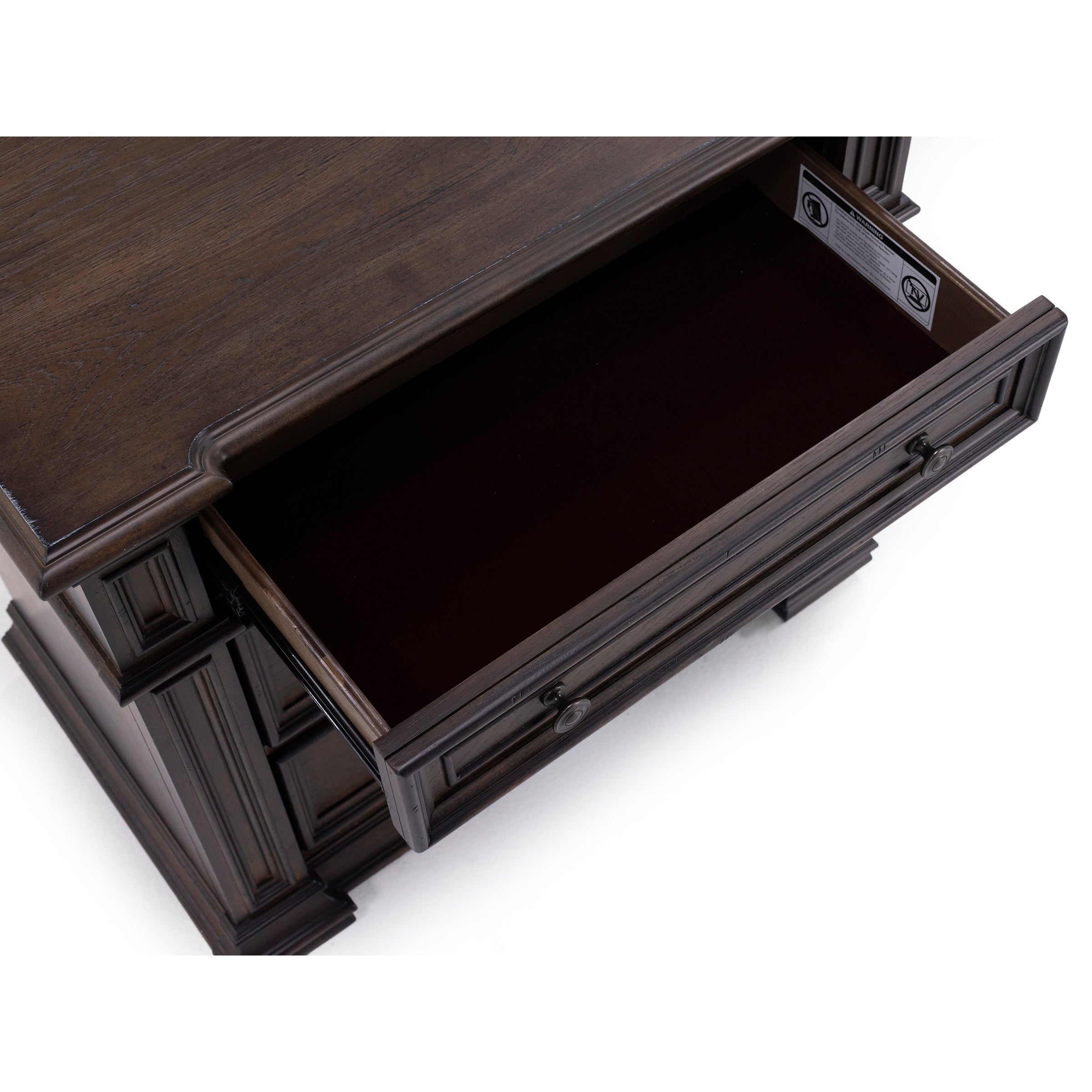 Open top drawer of dark wood desk, viewed from above.