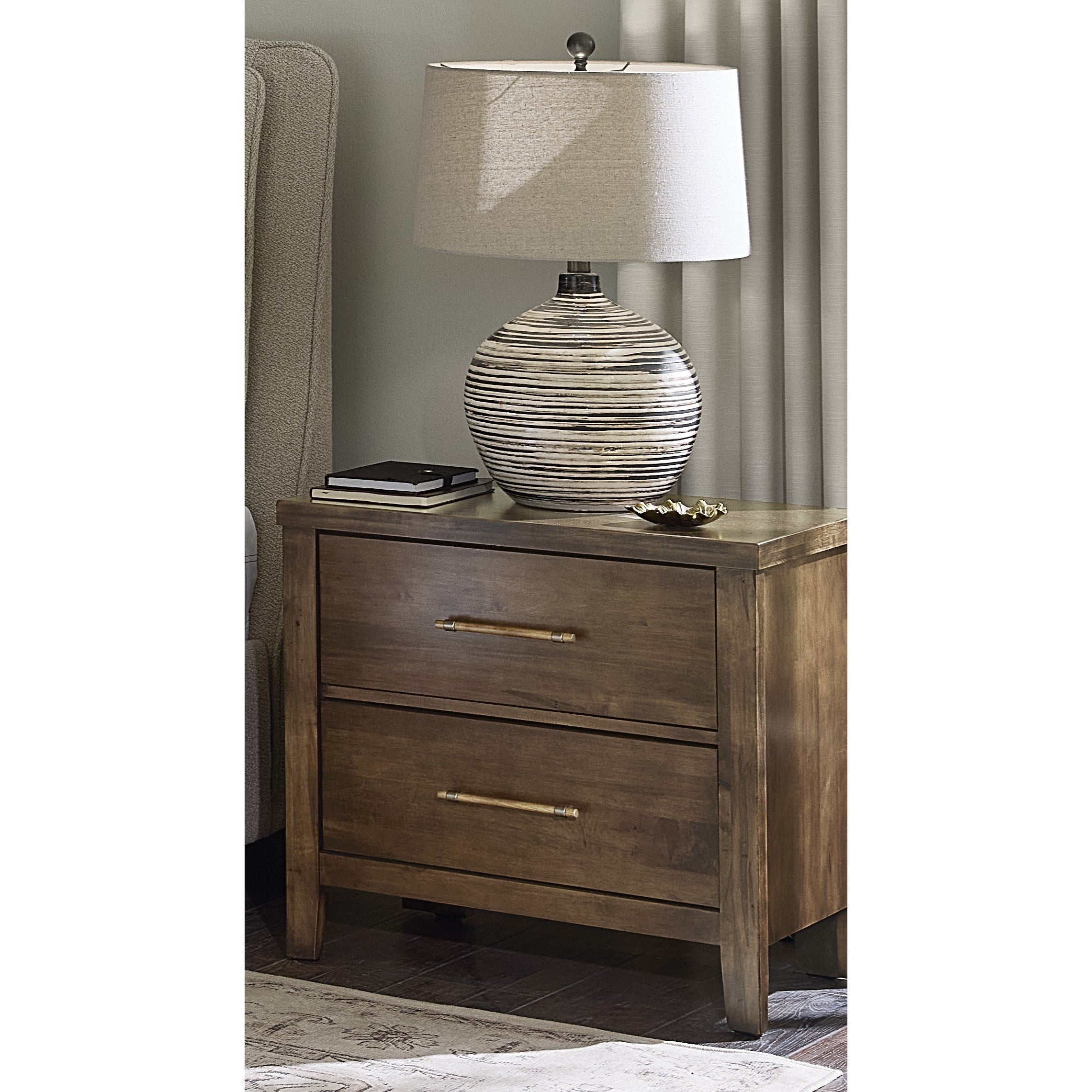 Wood nightstand with two drawers and a lamp on top.