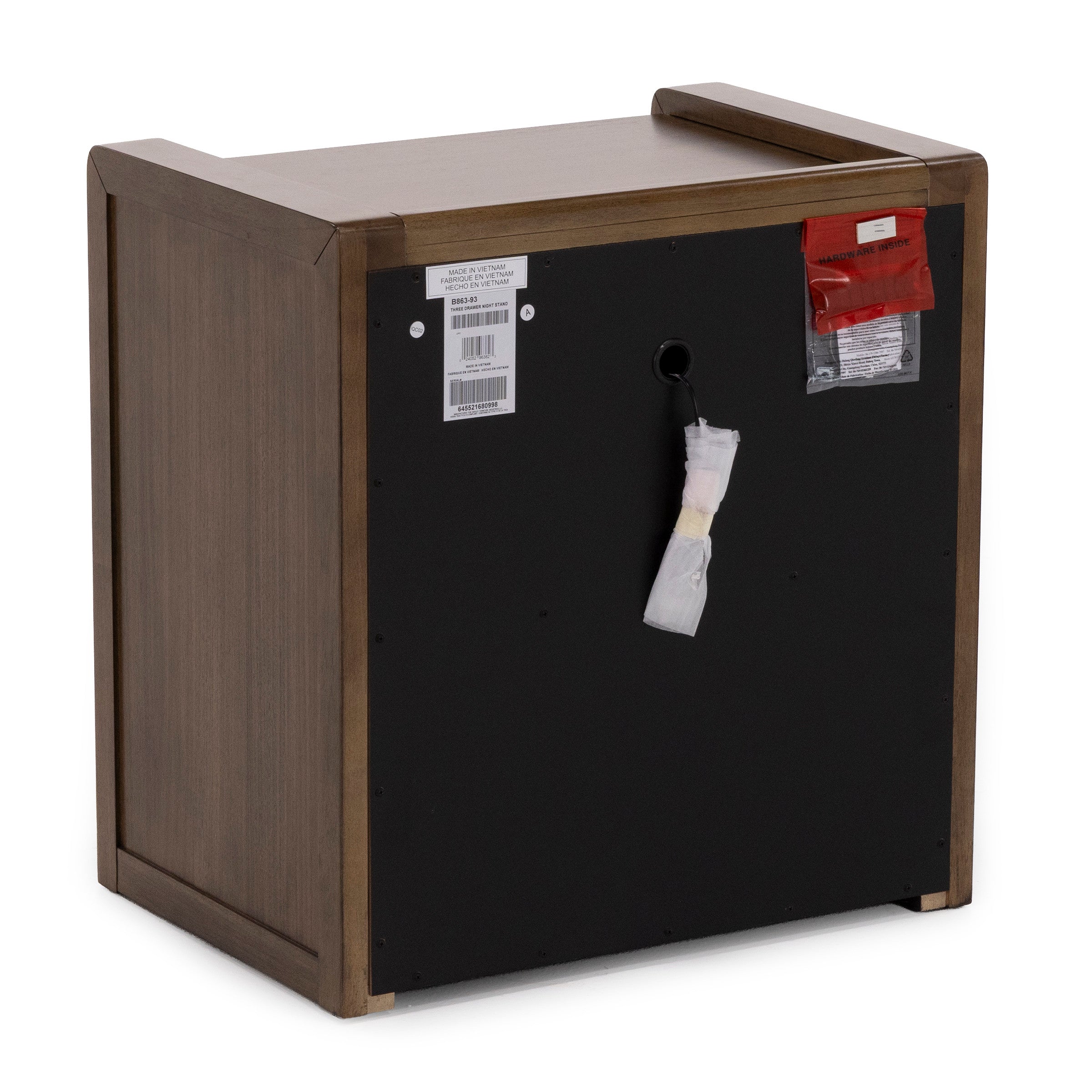 Back view of a wooden nightstand with hardware and labels attached.