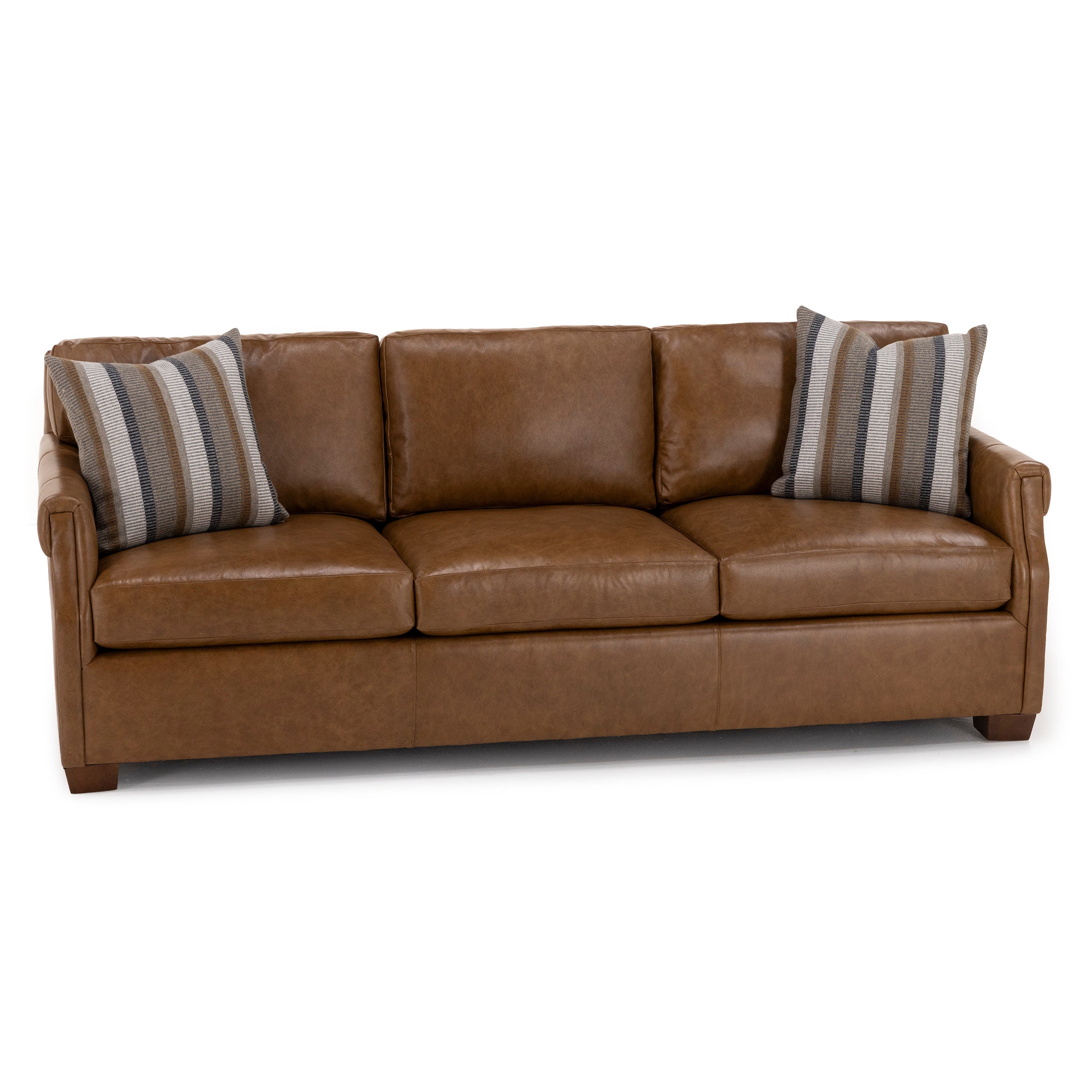 Brown leather sofa with three seat cushions and two striped accent pillows.