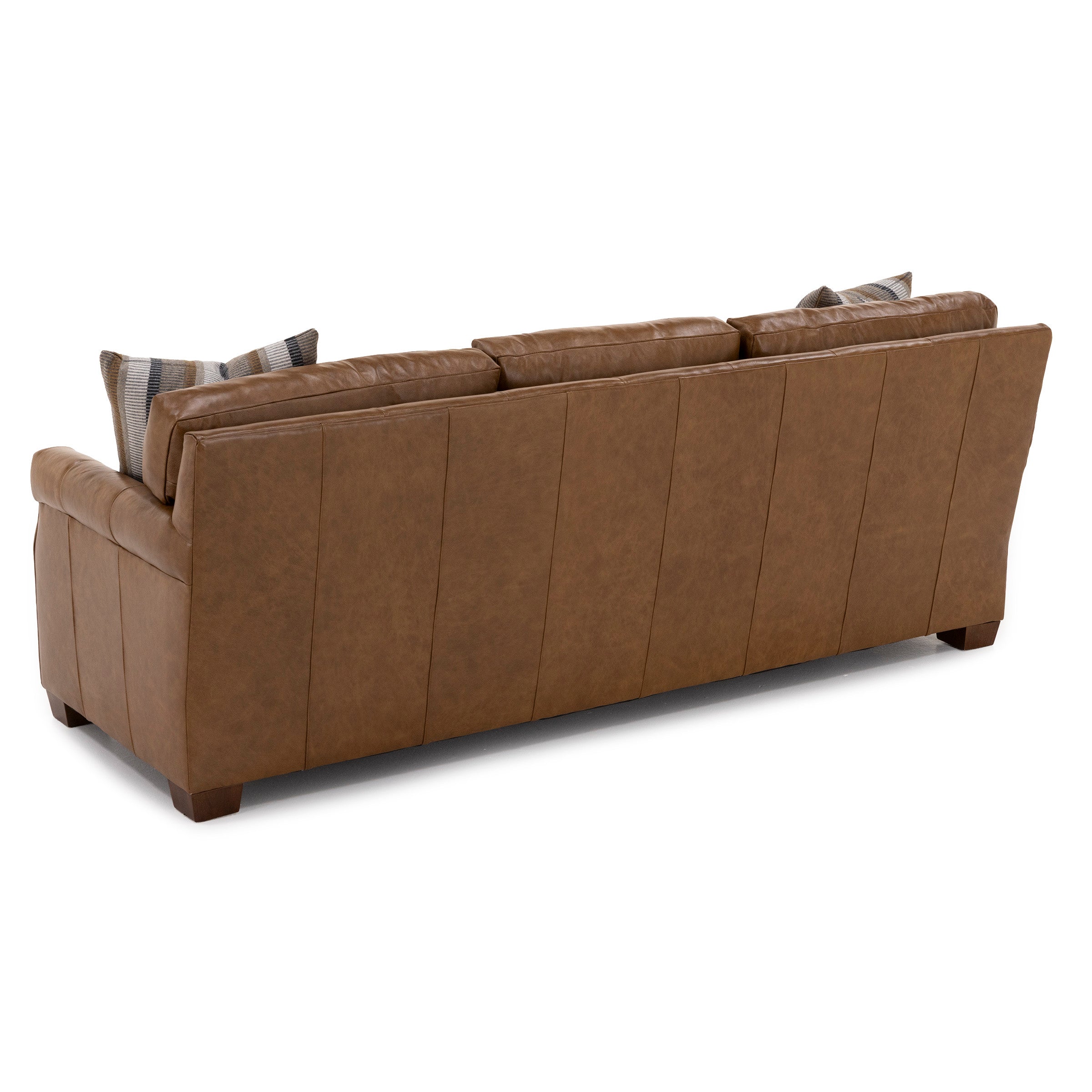 Back view of a brown leather sofa with three cushions and striped accent pillows.