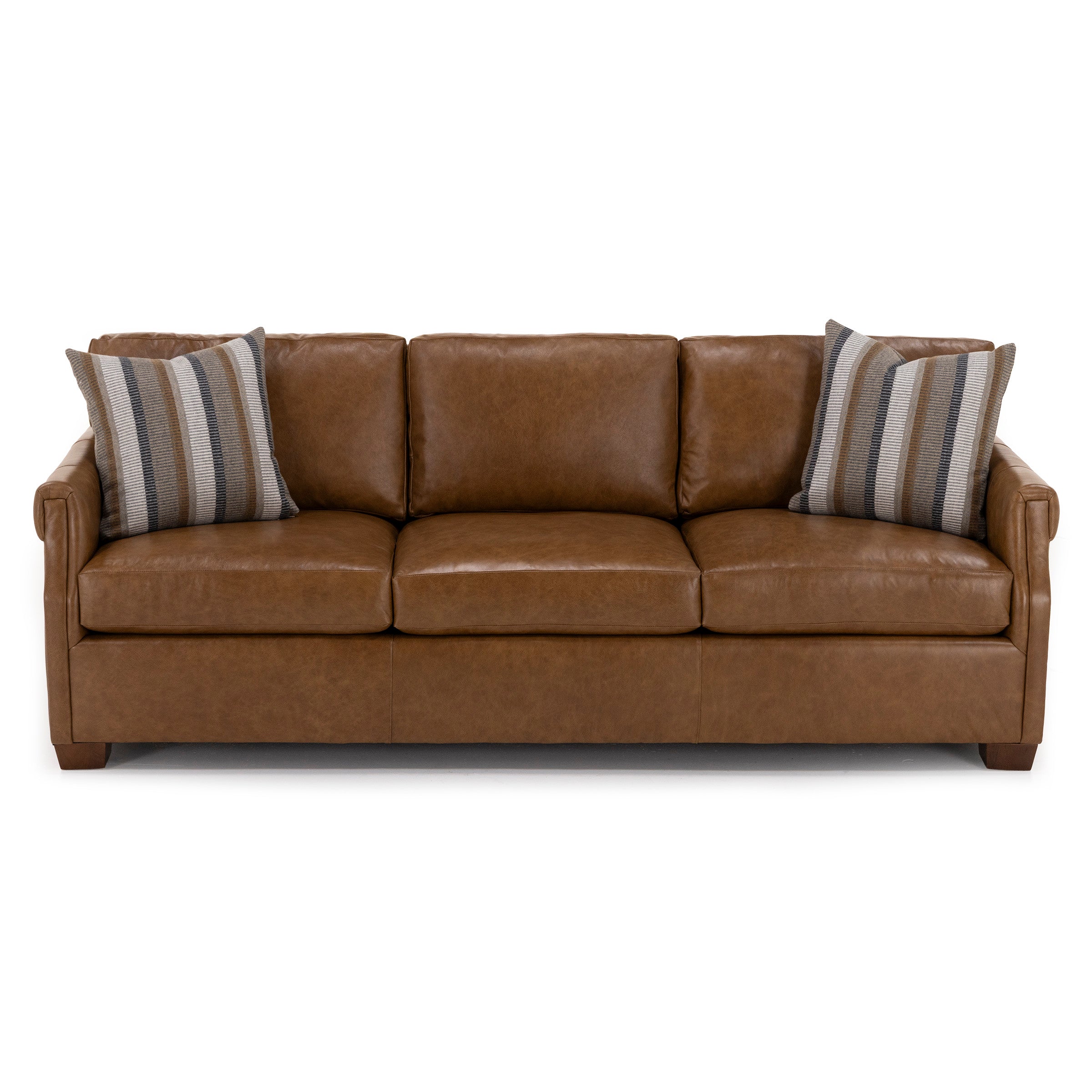 Brown leather sofa with three cushions and two striped accent pillows.