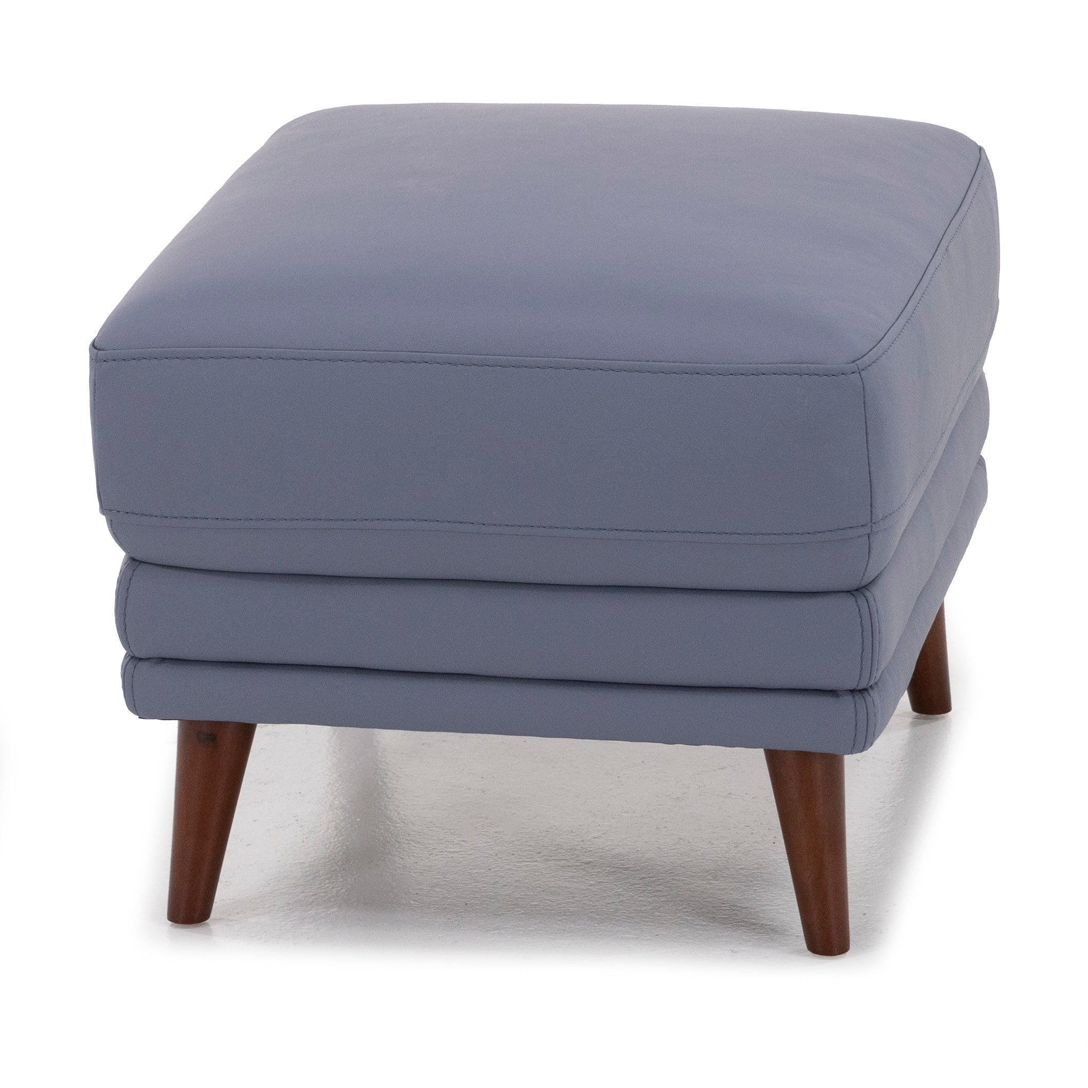 Square blue ottoman with wood legs on a white background.
