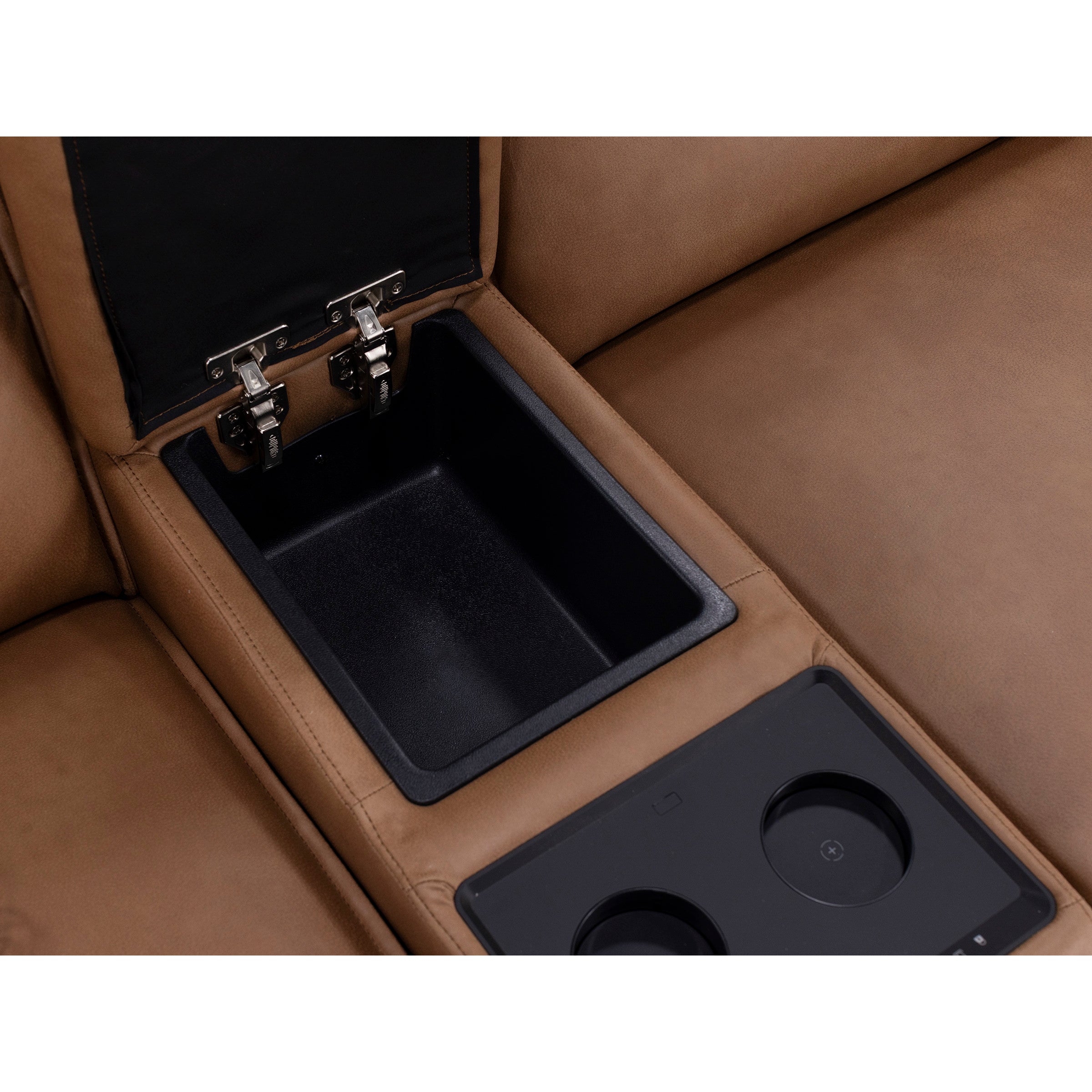 Brown sofa armrest with open storage compartment and built-in cup holders.