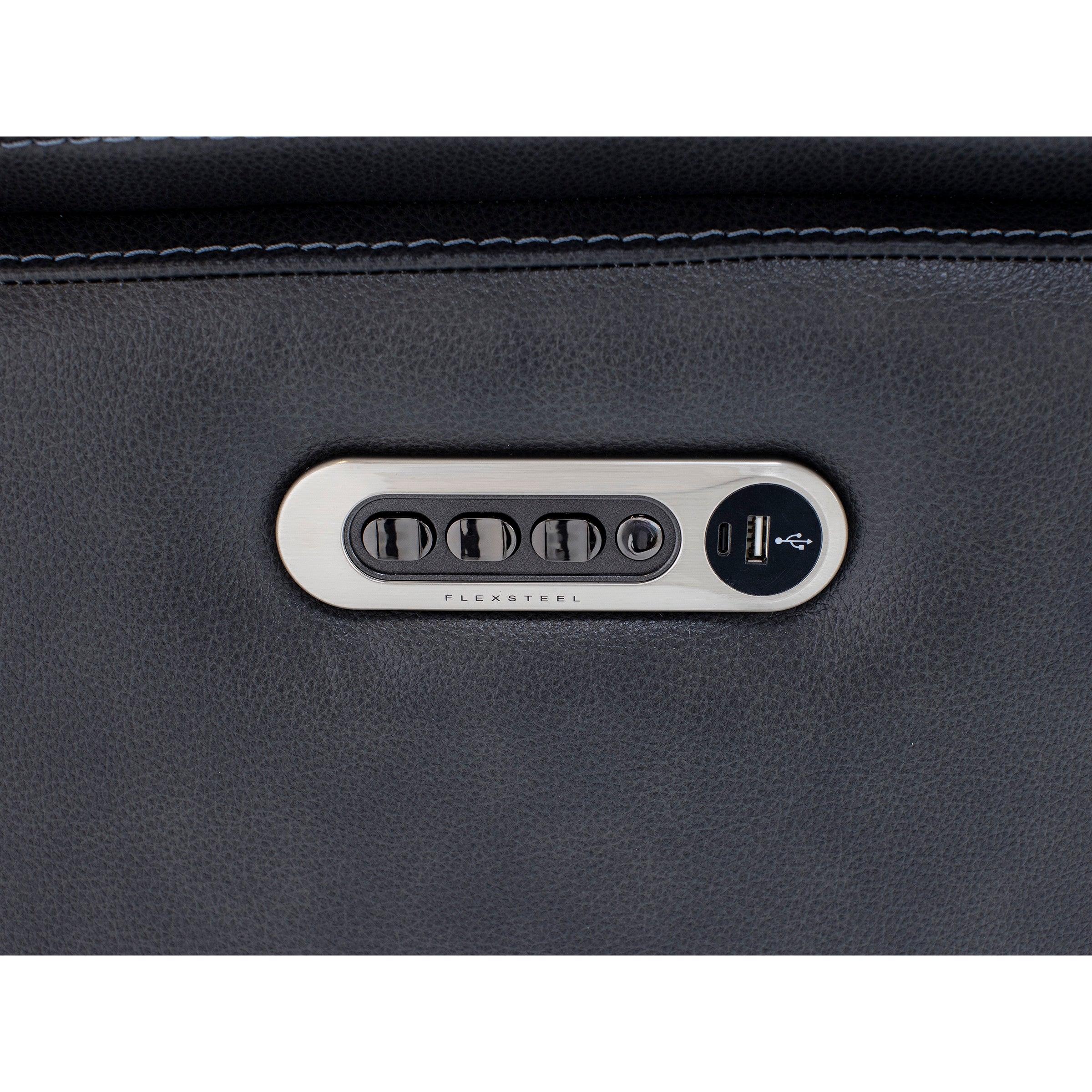 Close-up of Flexsteel recliner controls and USB charging ports on dark upholstery.