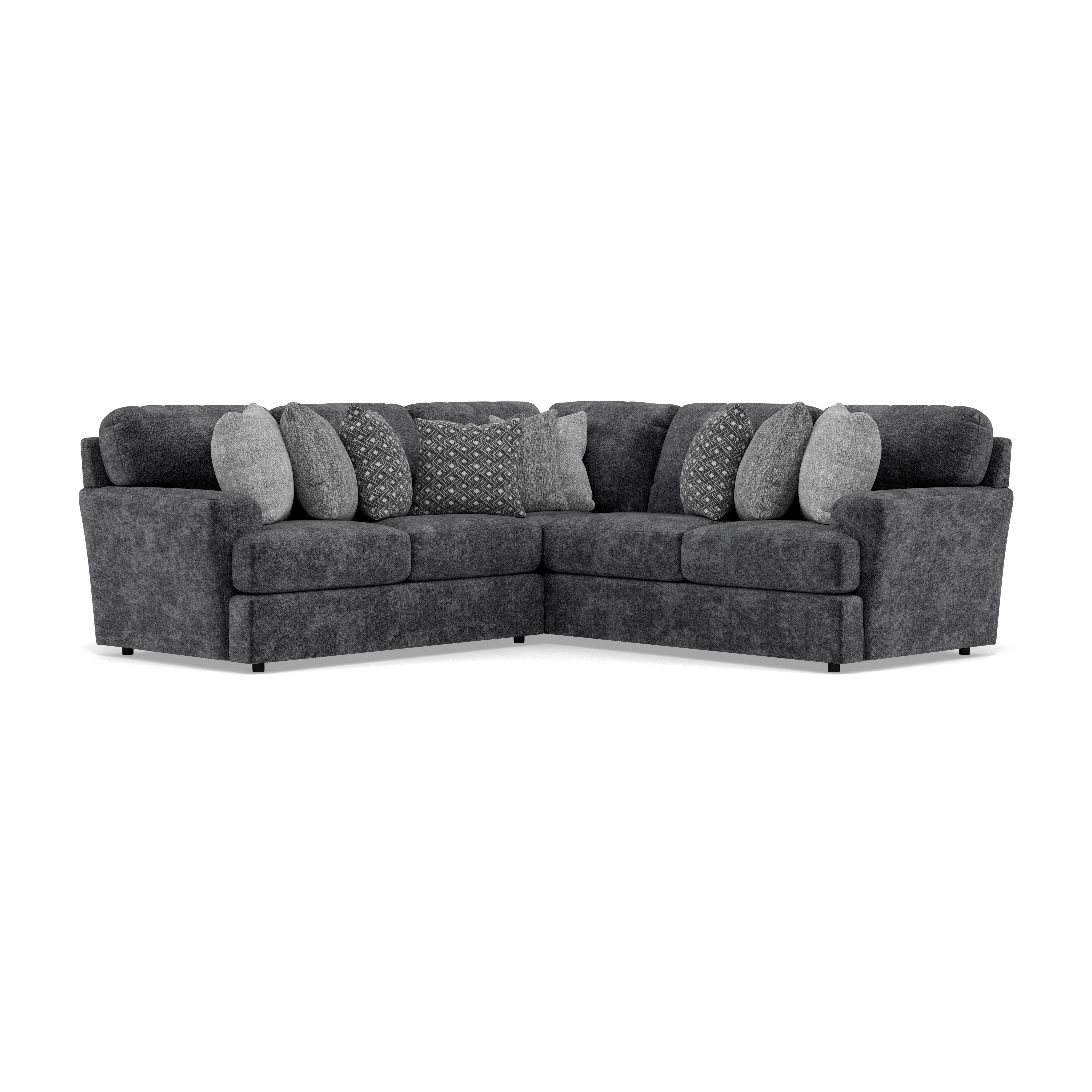 Dark gray sectional sofa with multiple patterned and solid throw pillows.