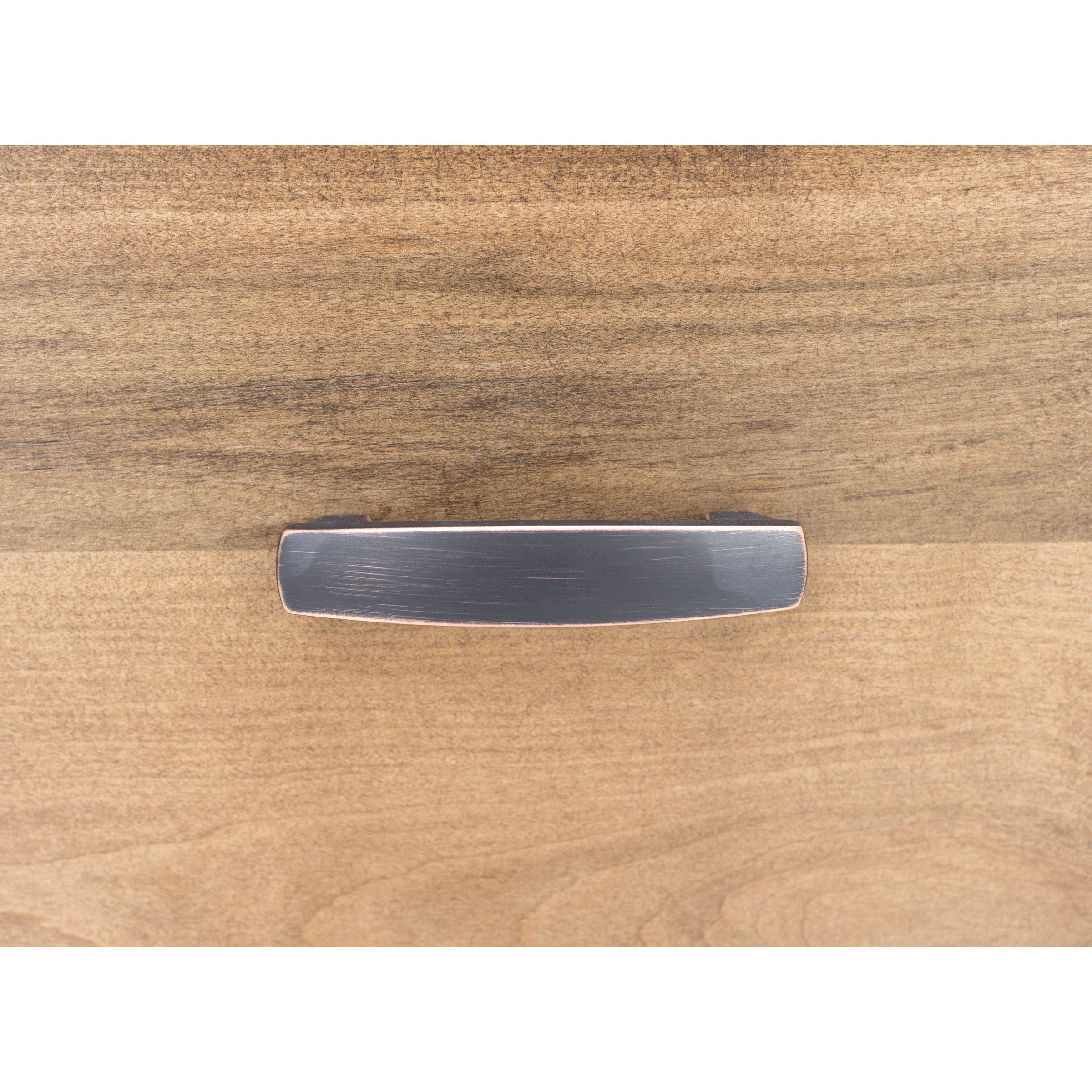 Rectangular metal drawer pull with brushed finish on wood surface.