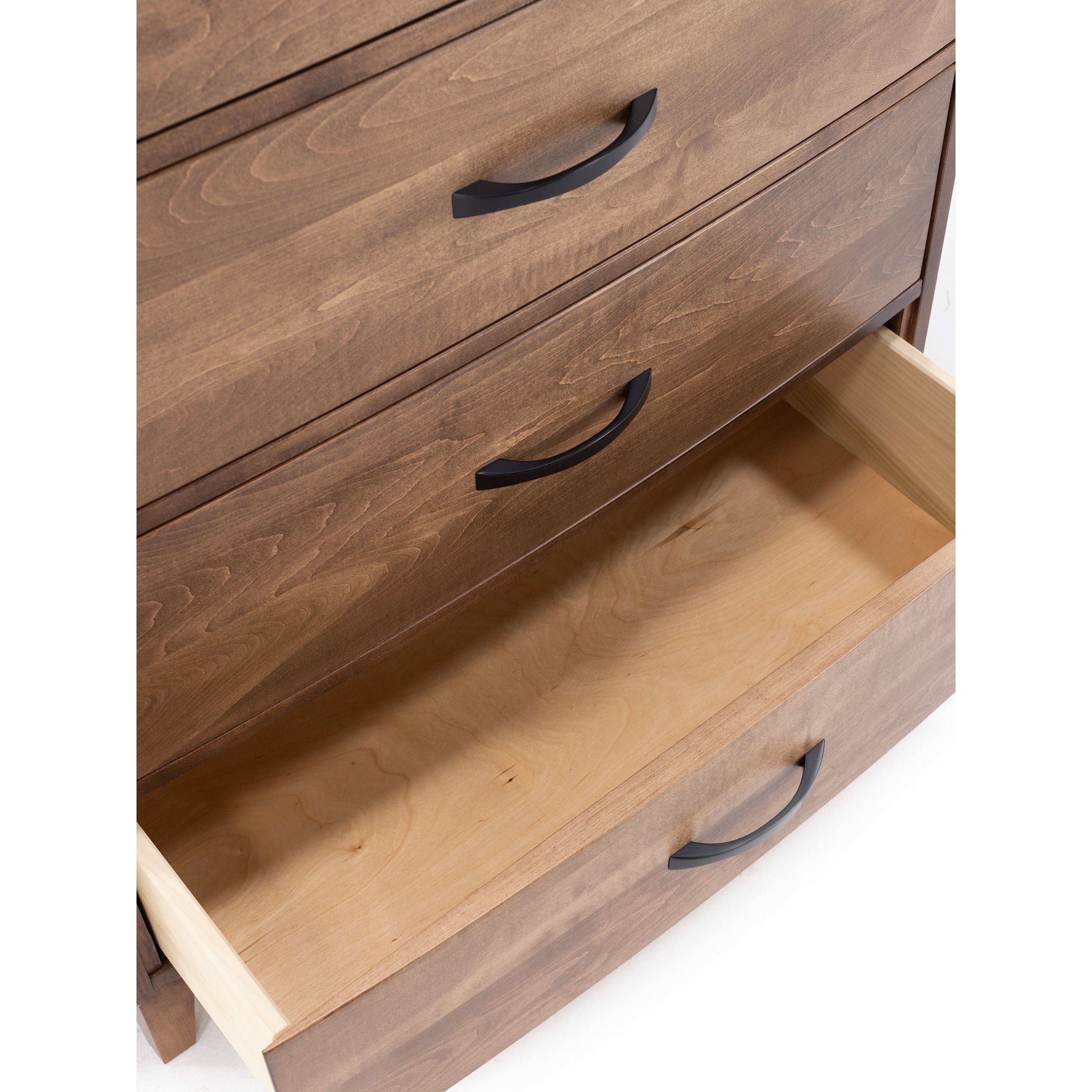 Wooden dresser with an open drawer and black handles.