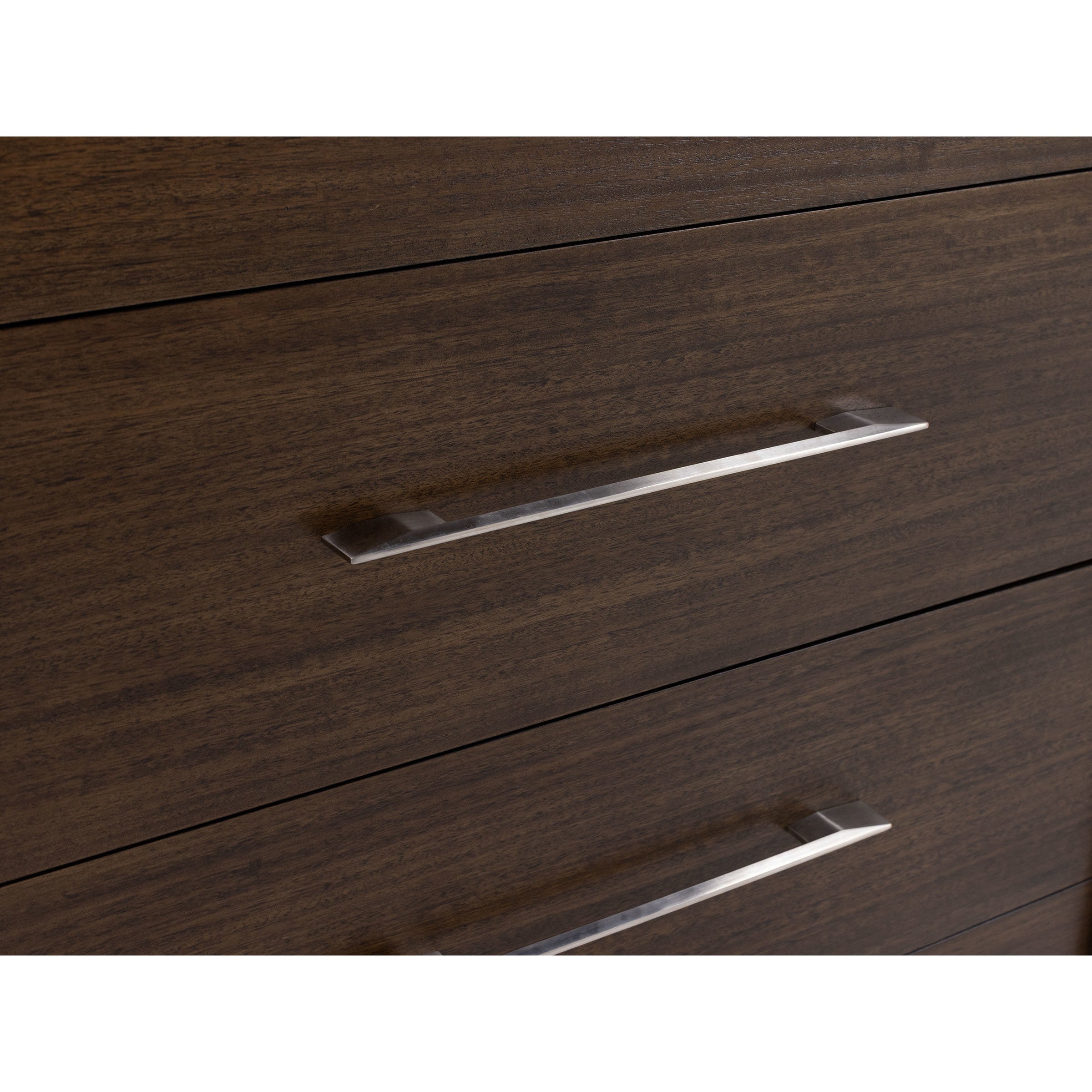 Close-up of a dark wood dresser with modern metal handles.