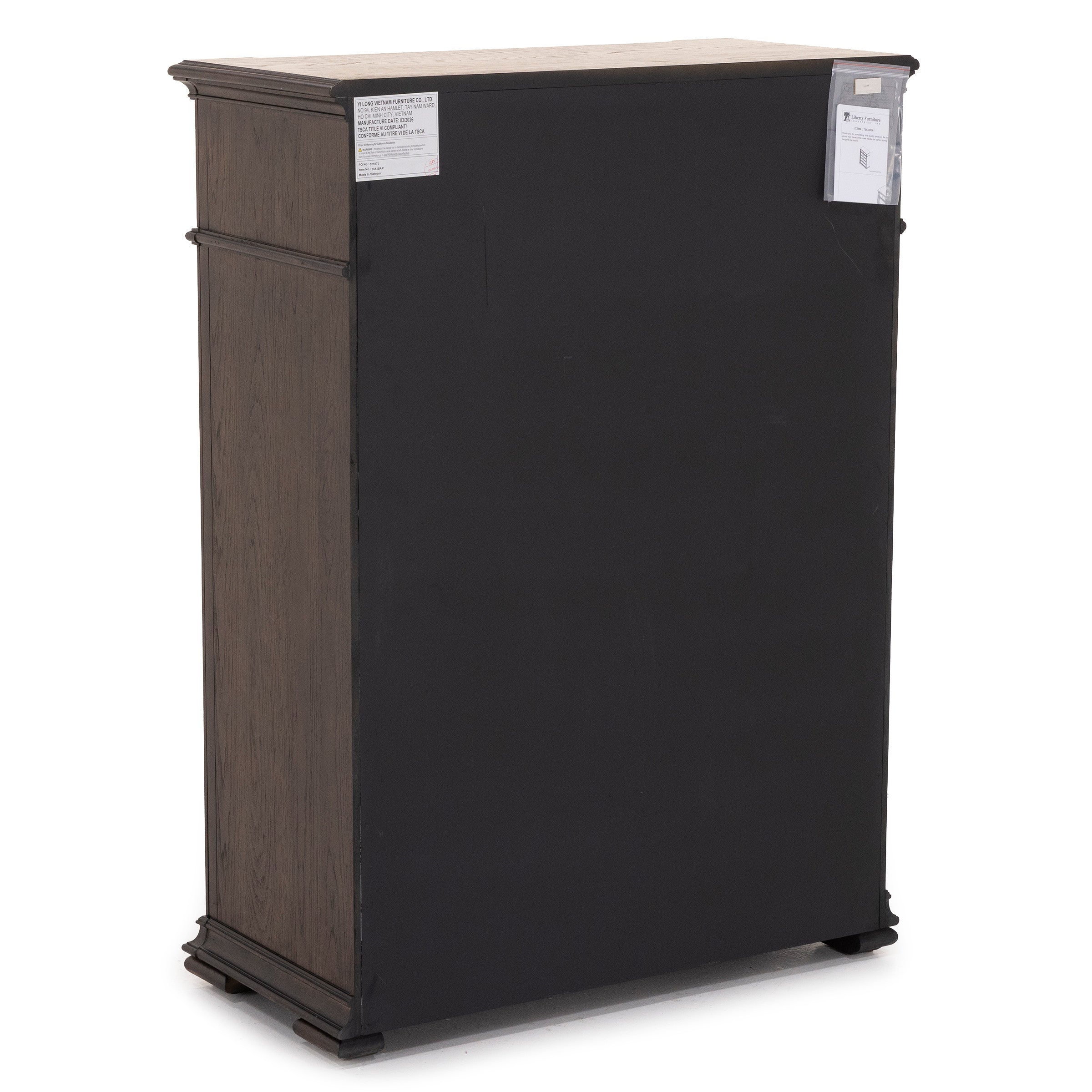 Back view of a tall wooden cabinet with dark panel, product labels visible in upper corners.