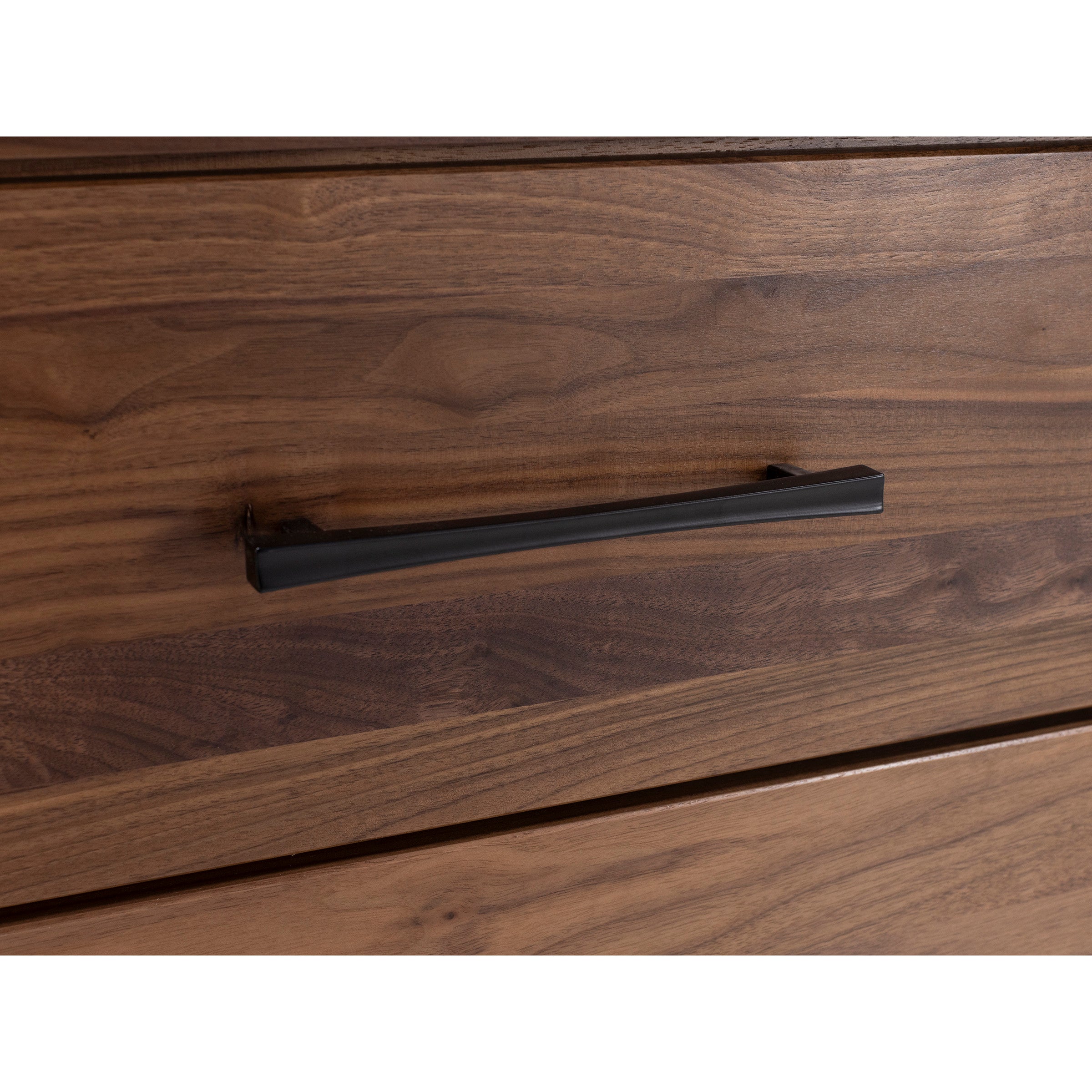 Close-up of a wooden drawer with a black metal handle.