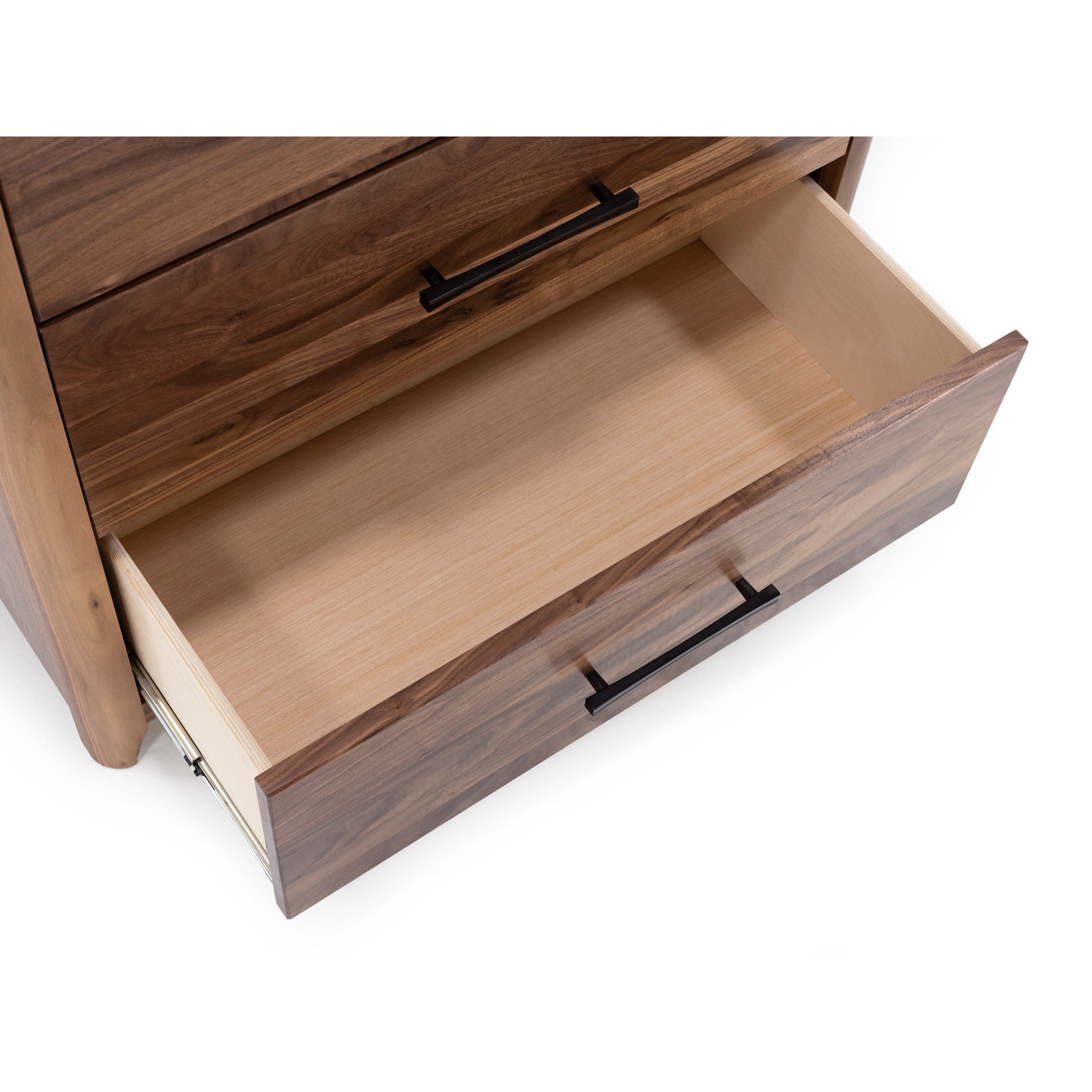 Open wooden drawer with black handle on a dresser, shown from above.