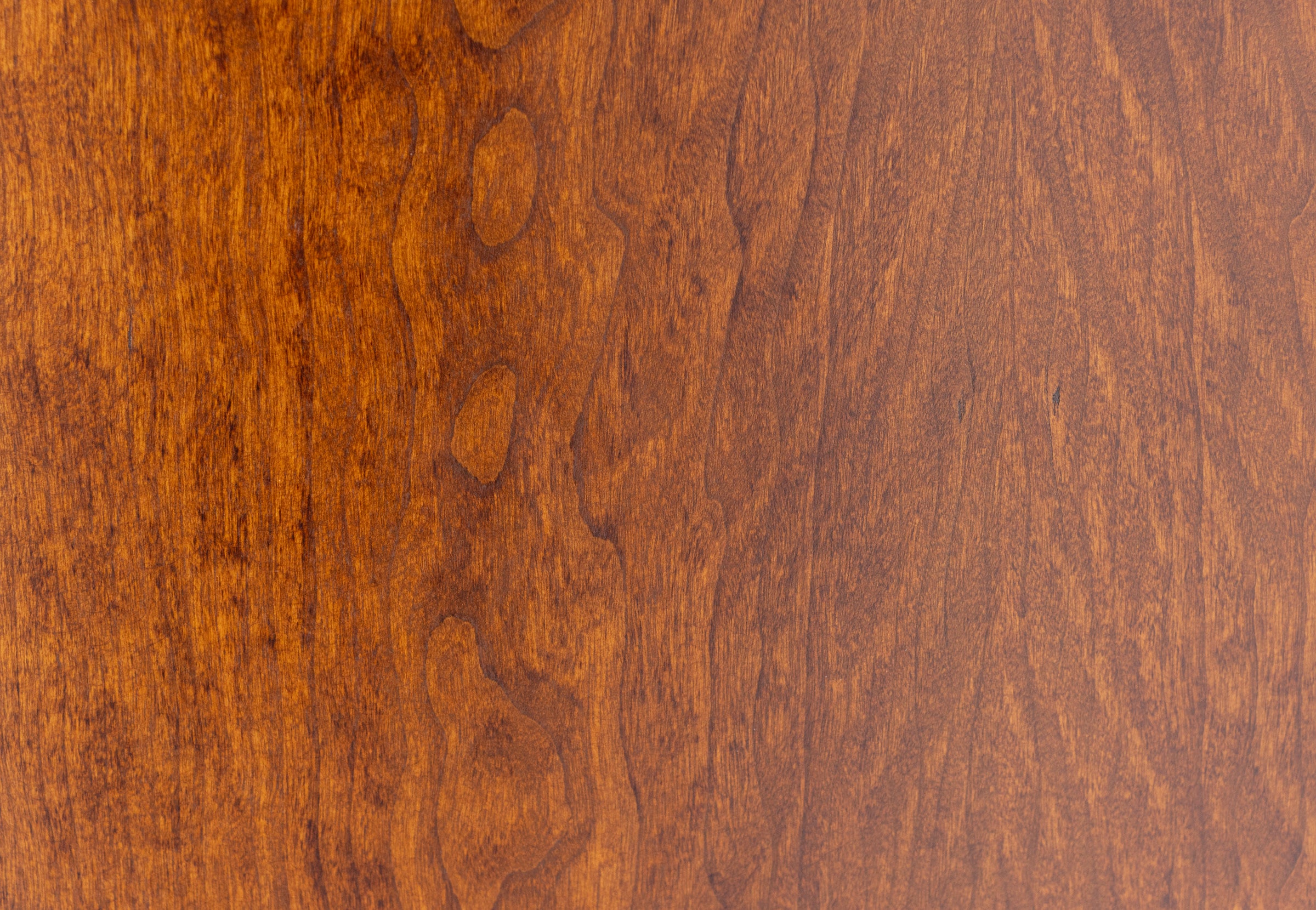 Close-up of a warm brown wood grain surface.