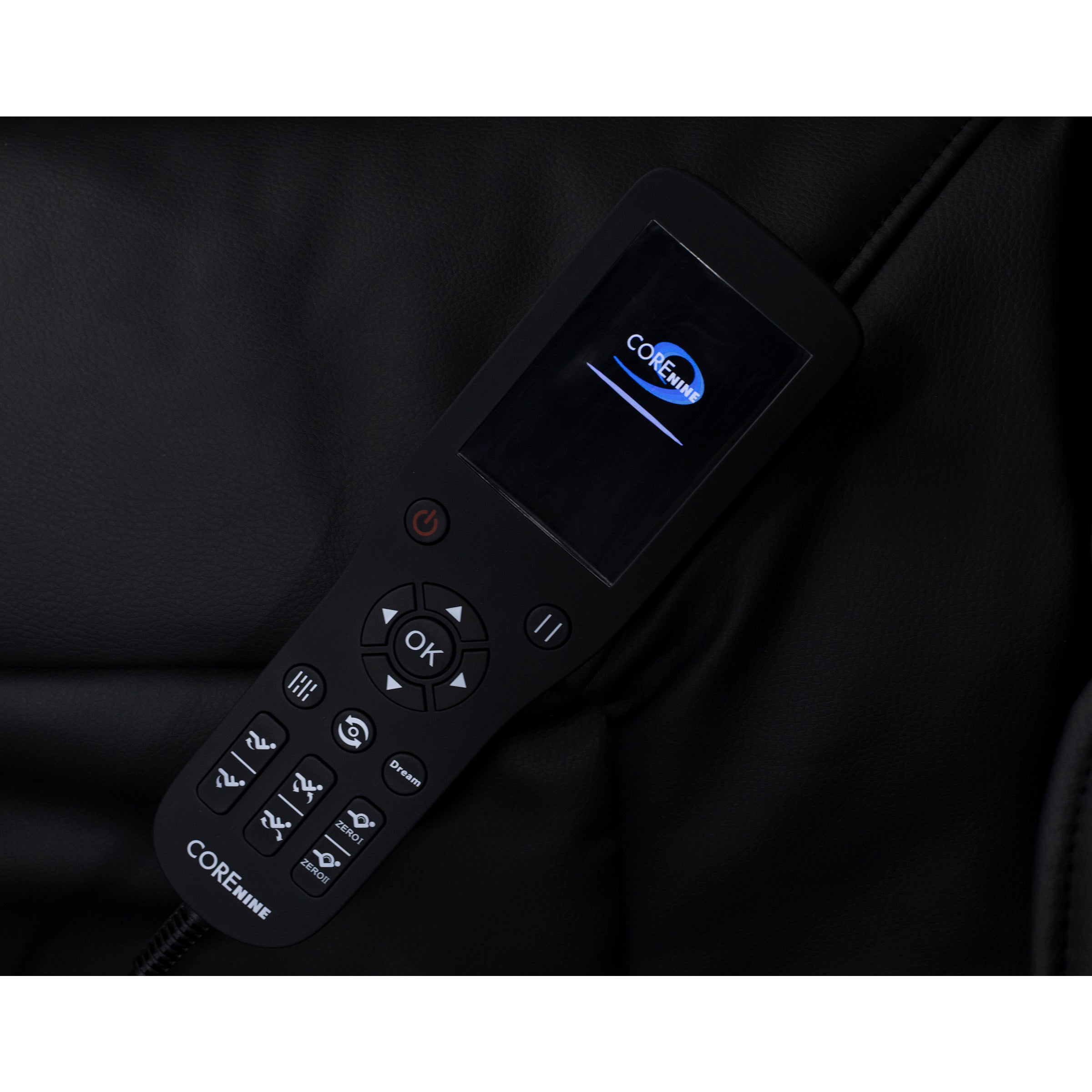 Black remote control with screen displaying 'CORE NINE' logo on a leather surface.