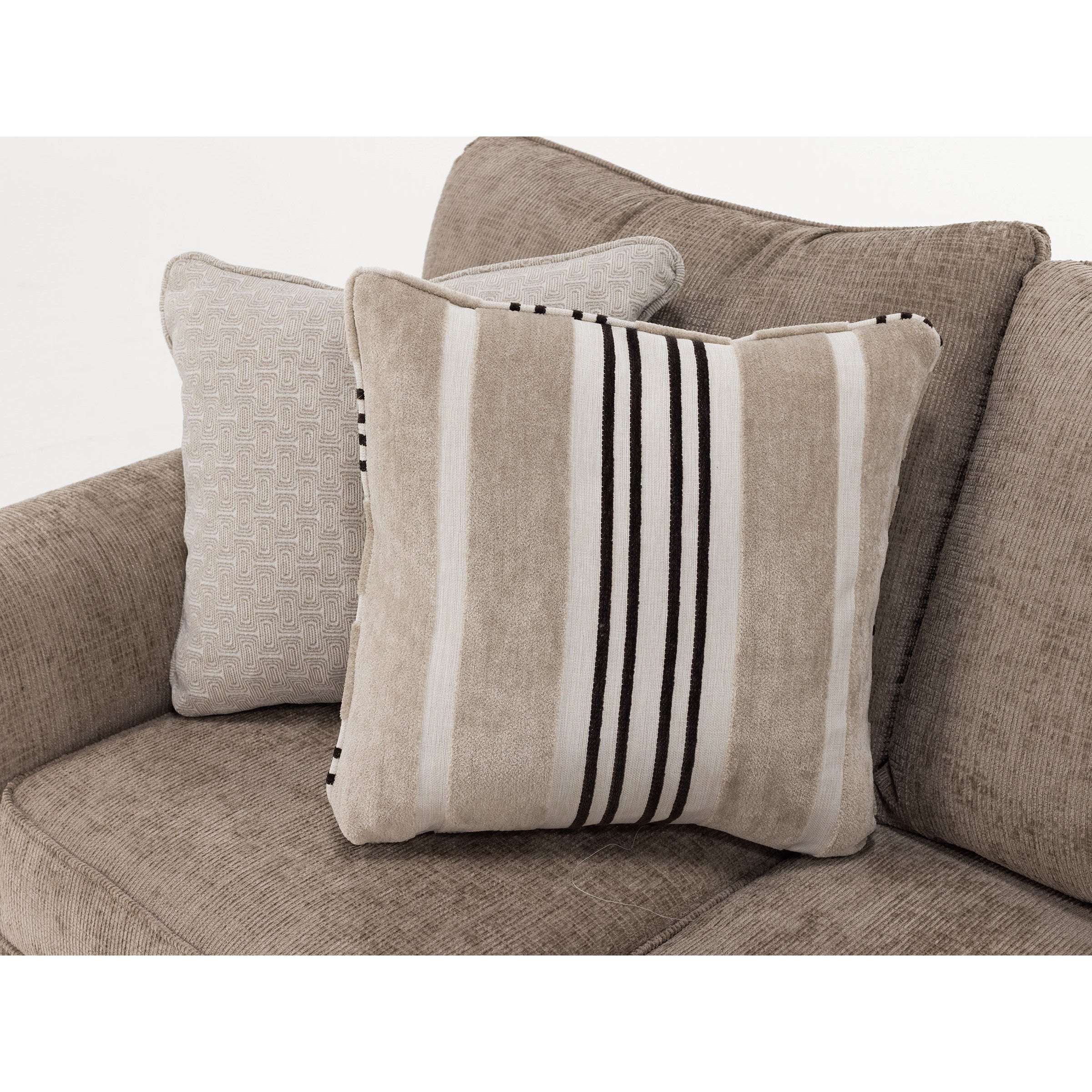 Two decorative throw pillows on a beige upholstered sofa.
