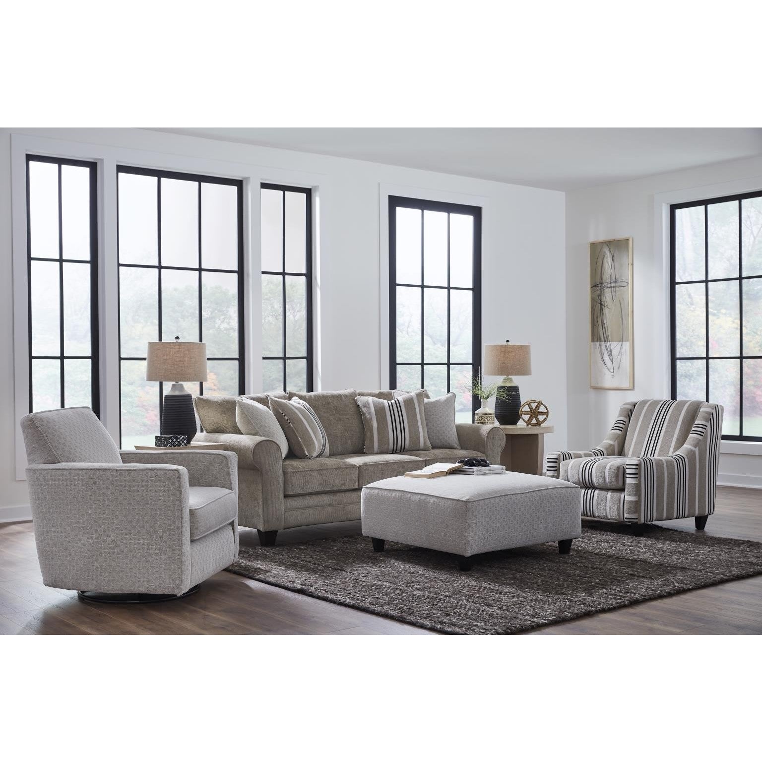 Modern living room with neutral furniture, large windows, and decorative accents.