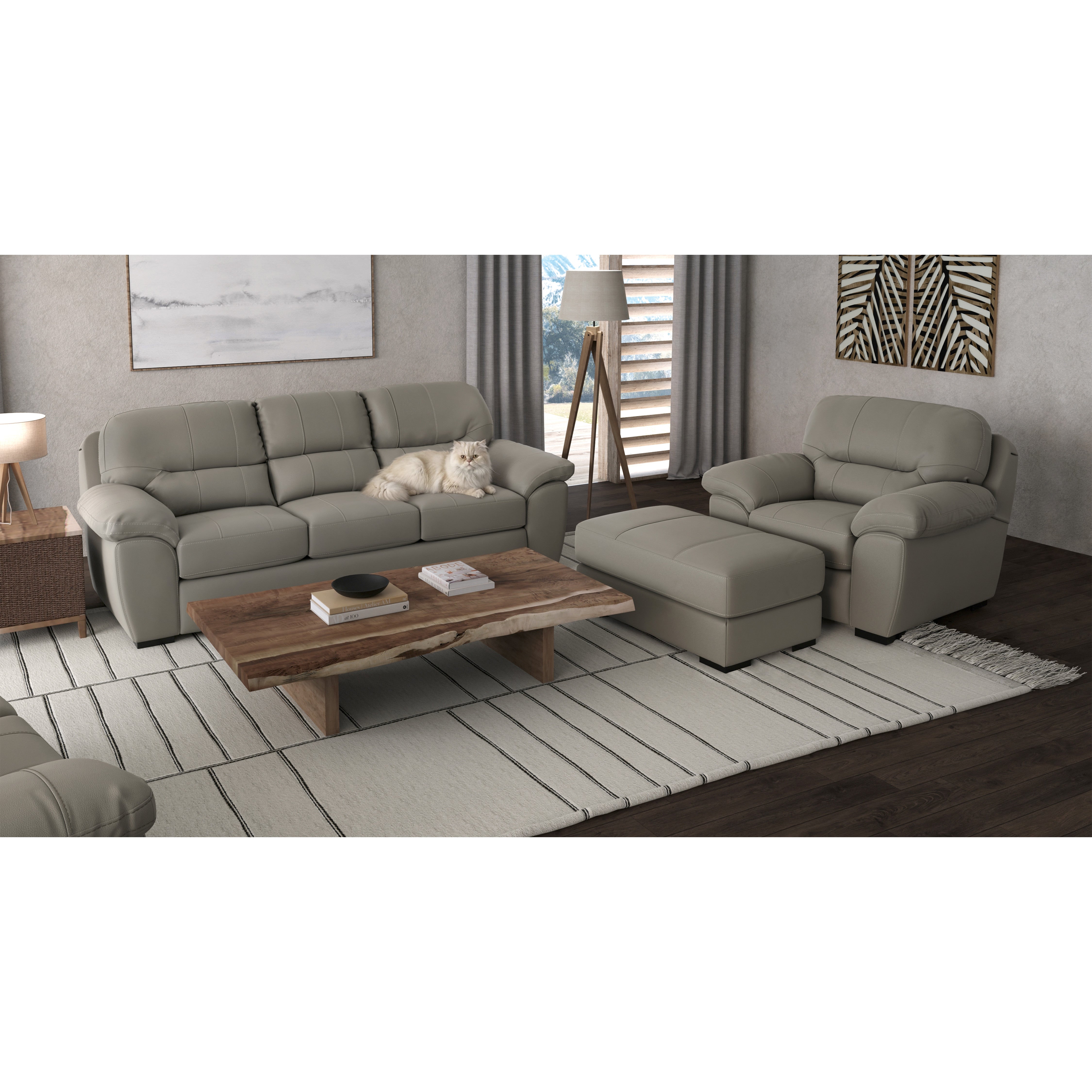 Modern living room with gray sofas, ottoman, wooden coffee table, and a white cat on the sofa.