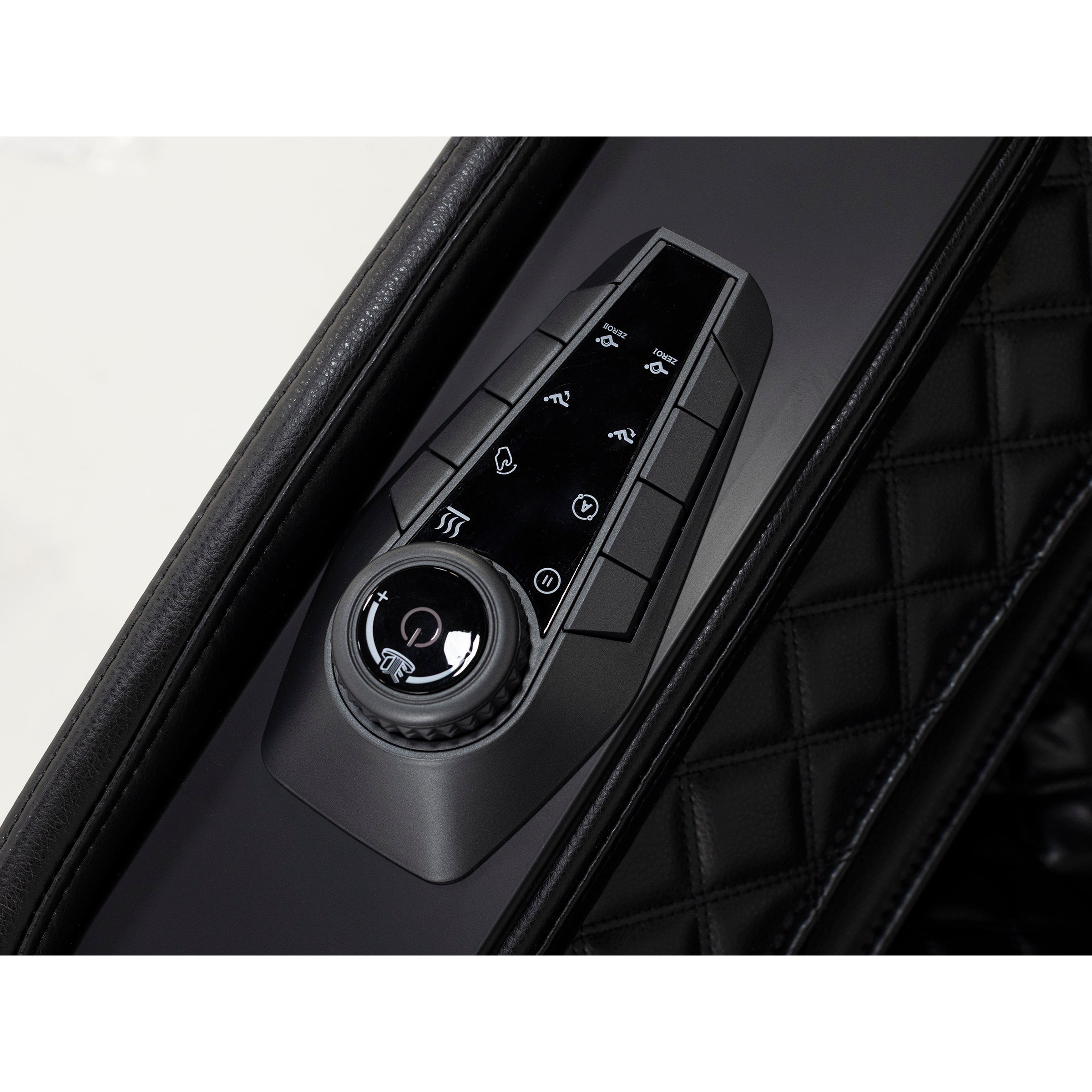 Close-up of a sleek control panel with buttons and dial in a black quilted setting.