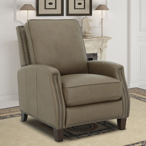 Taupe leather recliner chair with nailhead trim in a classic living room.
