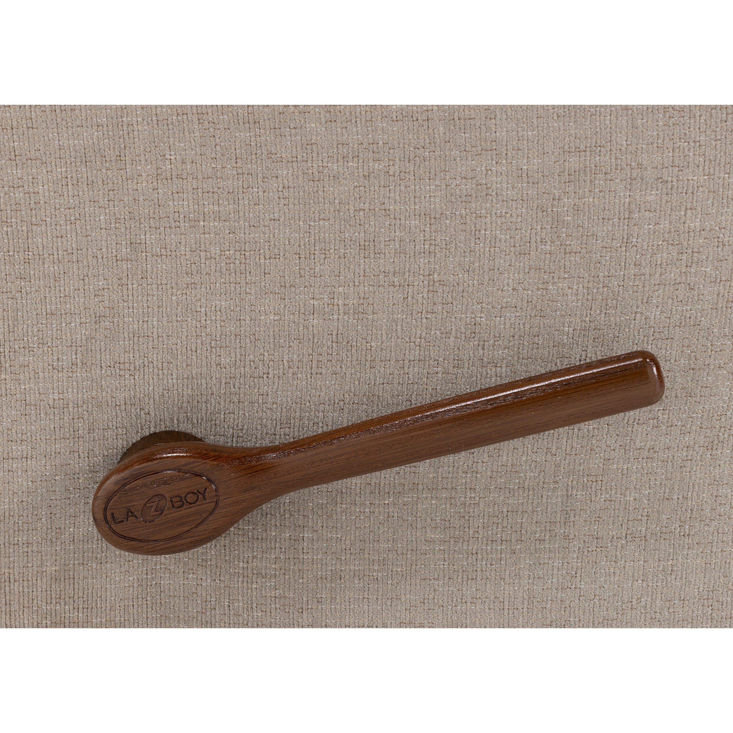 Brown wood recliner handle with LA-Z-BOY logo on beige fabric background.