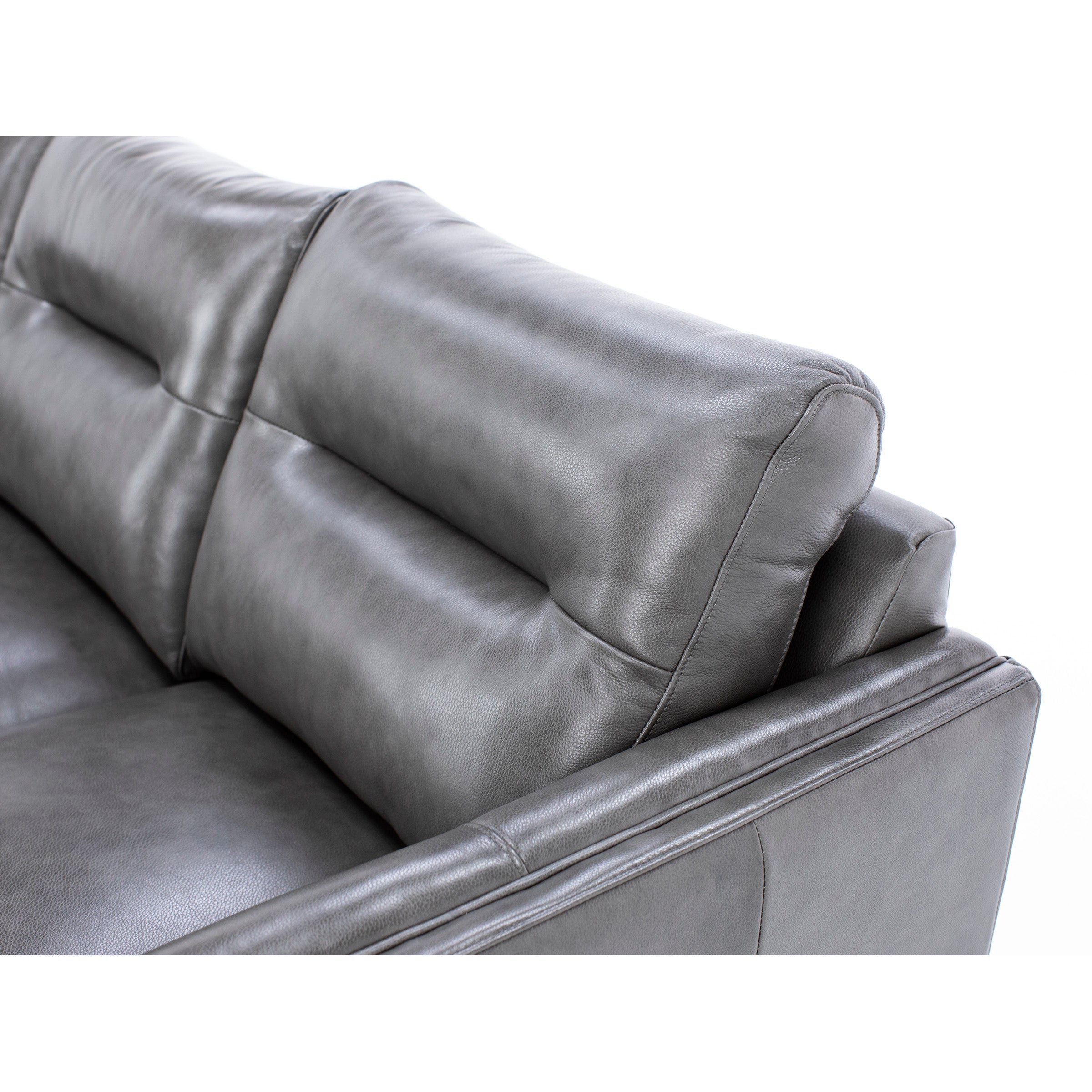 Close-up of gray leather sofa backrest and cushion.