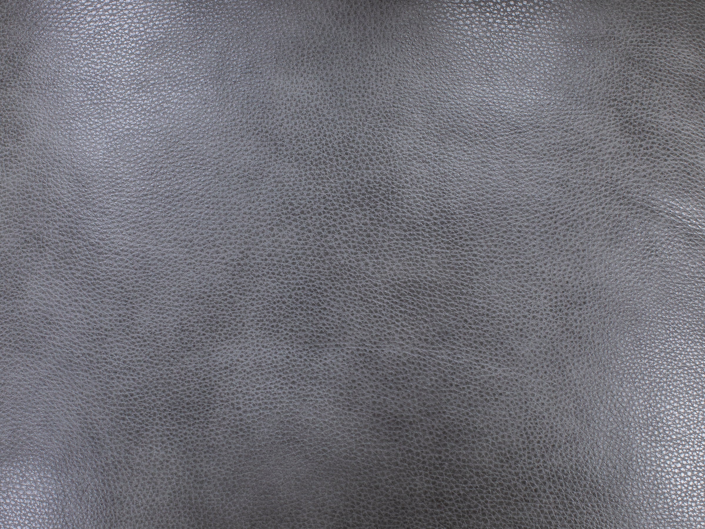 Close-up of gray textured leather surface.