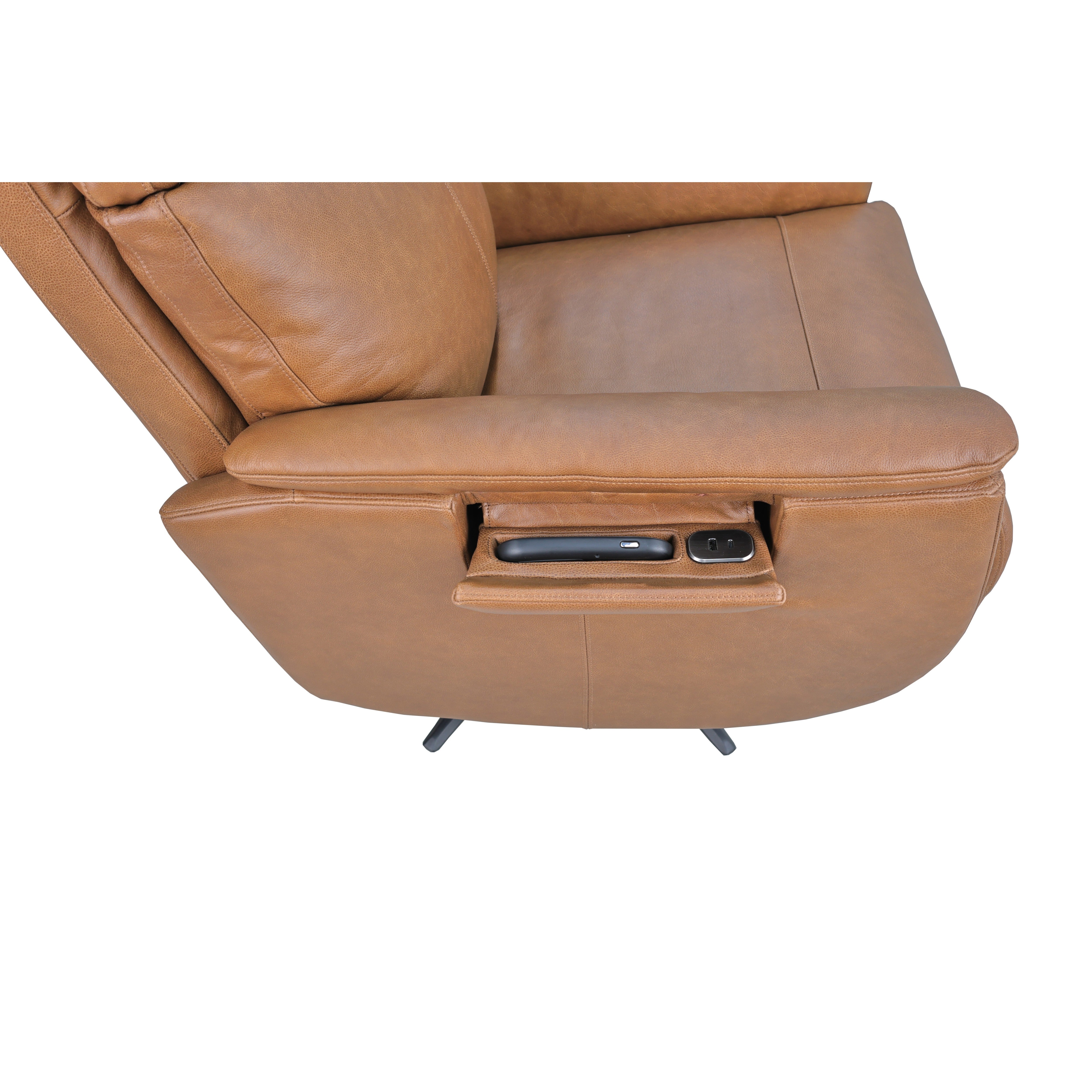 Close-up of a tan recliner armrest with built-in storage holding a remote and power outlets.