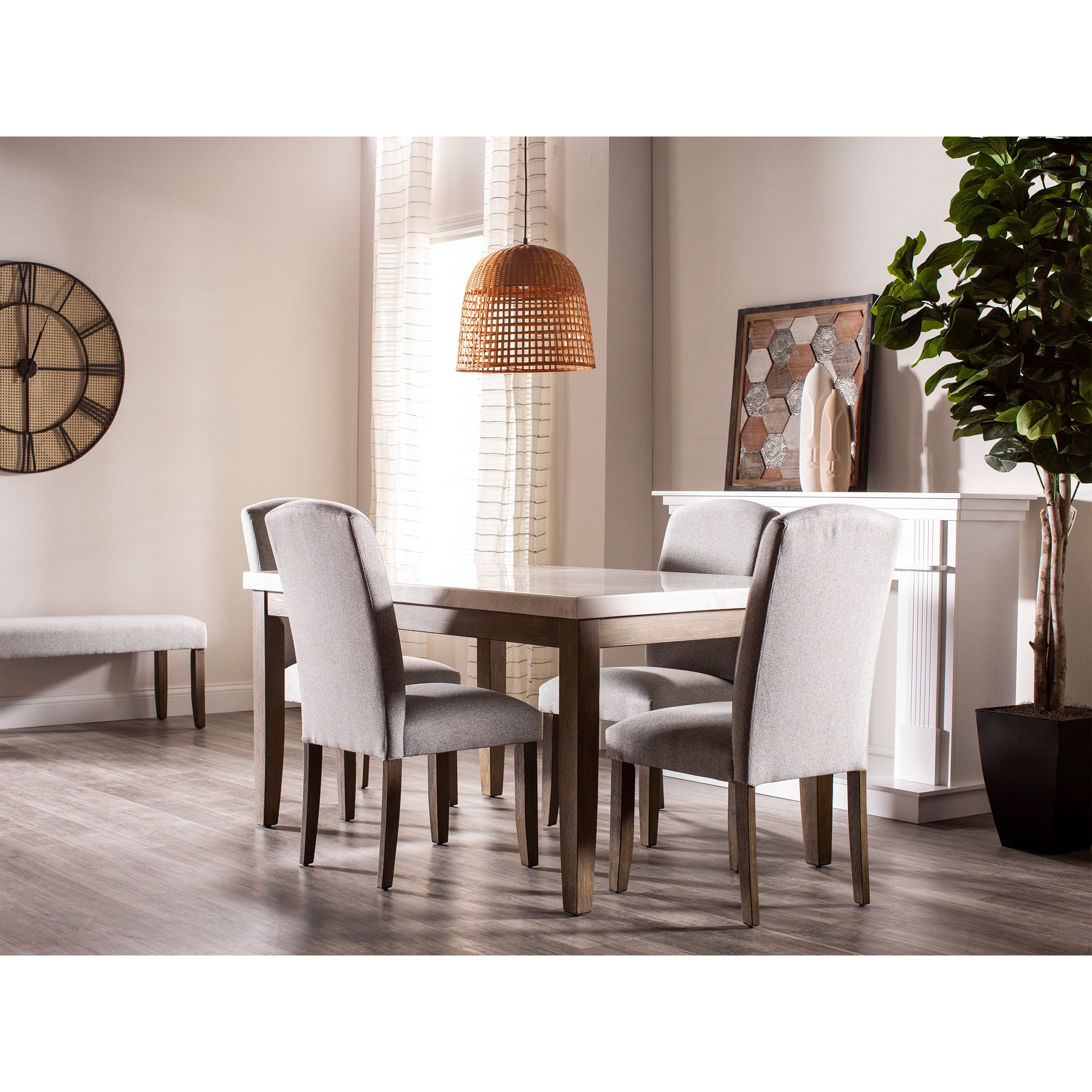 Modern dining room with grey upholstered chairs around a wooden table, plant, wall art, and clock.
