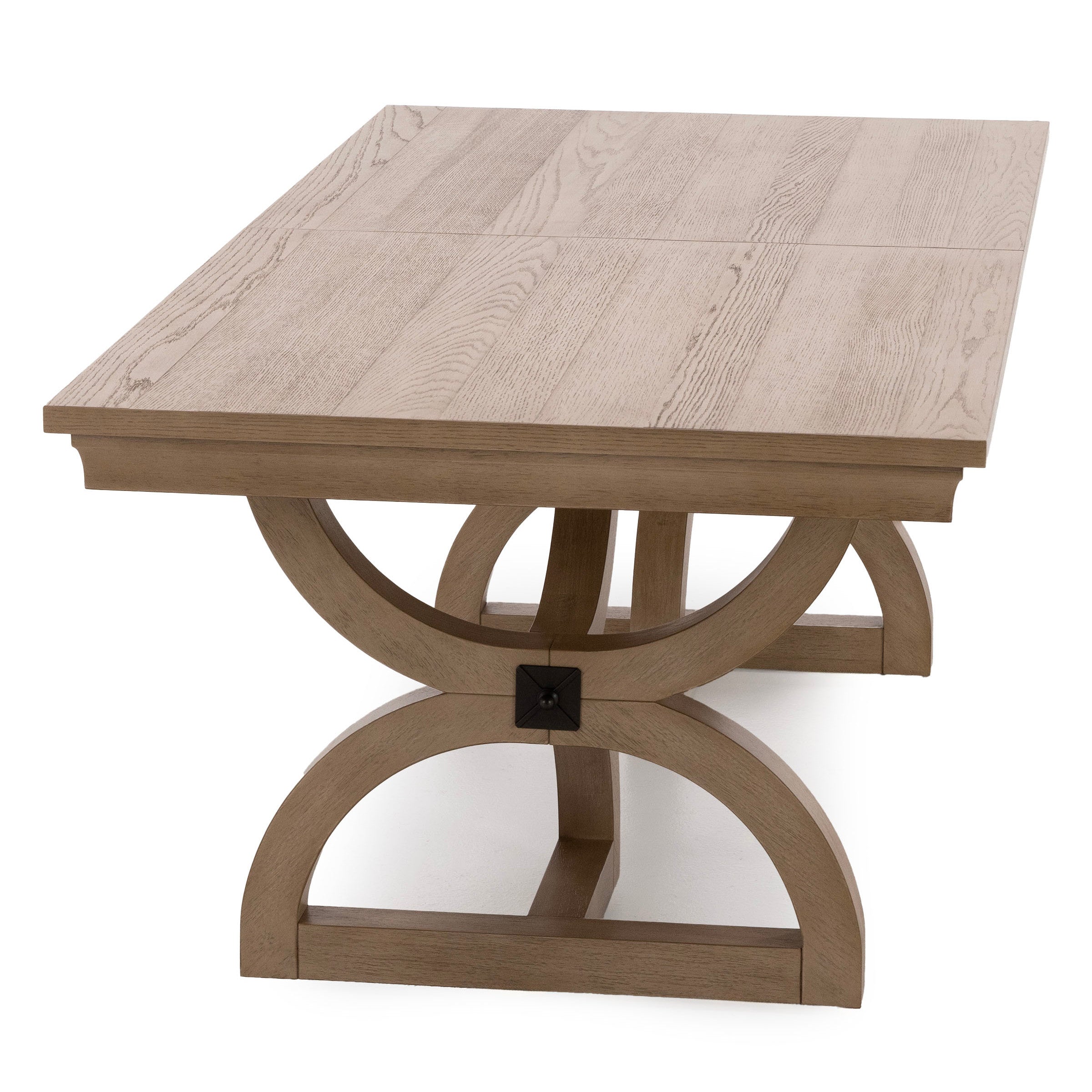 Light wood dining table with a geometric trestle base.