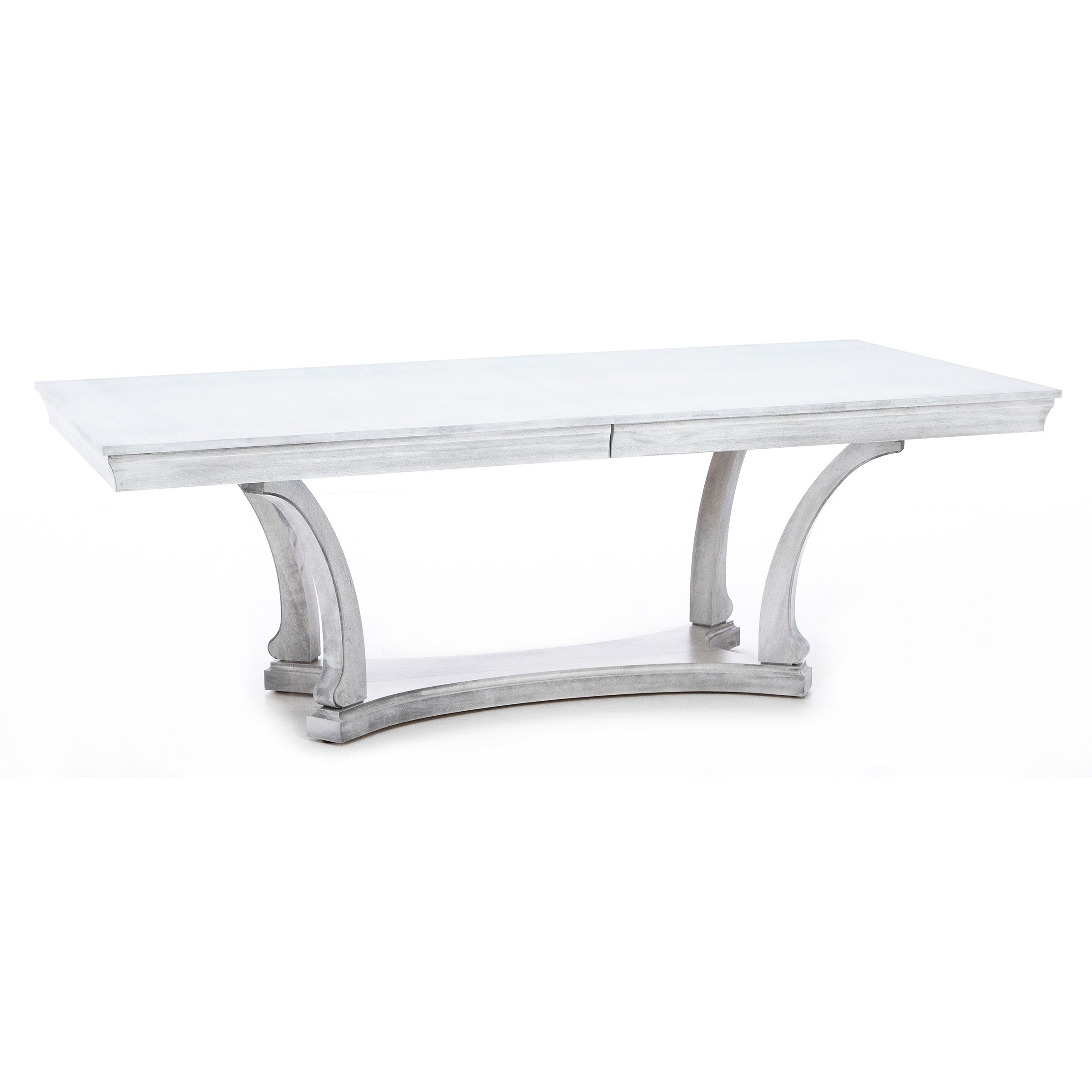 Rectangular dining table with a whitewashed wood finish and decorative curved base.