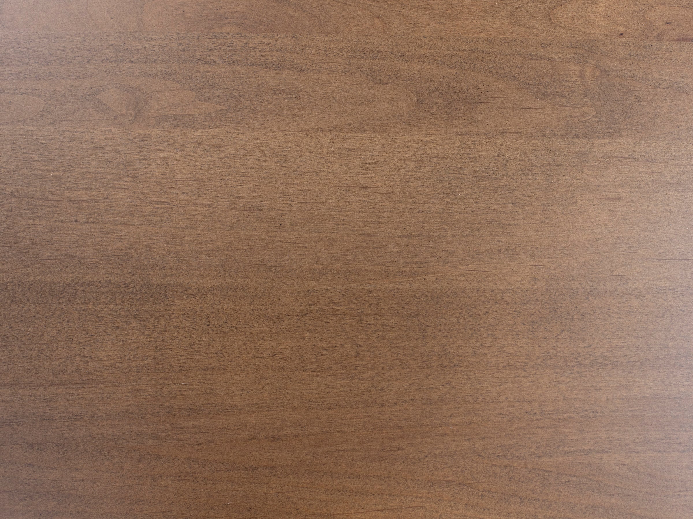 Light brown wood surface with visible grain pattern.