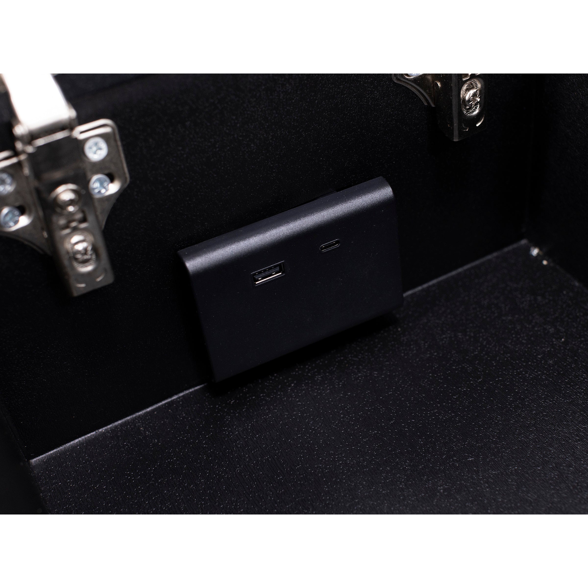 Close-up of a black USB and USB-C charging port inside a black box.