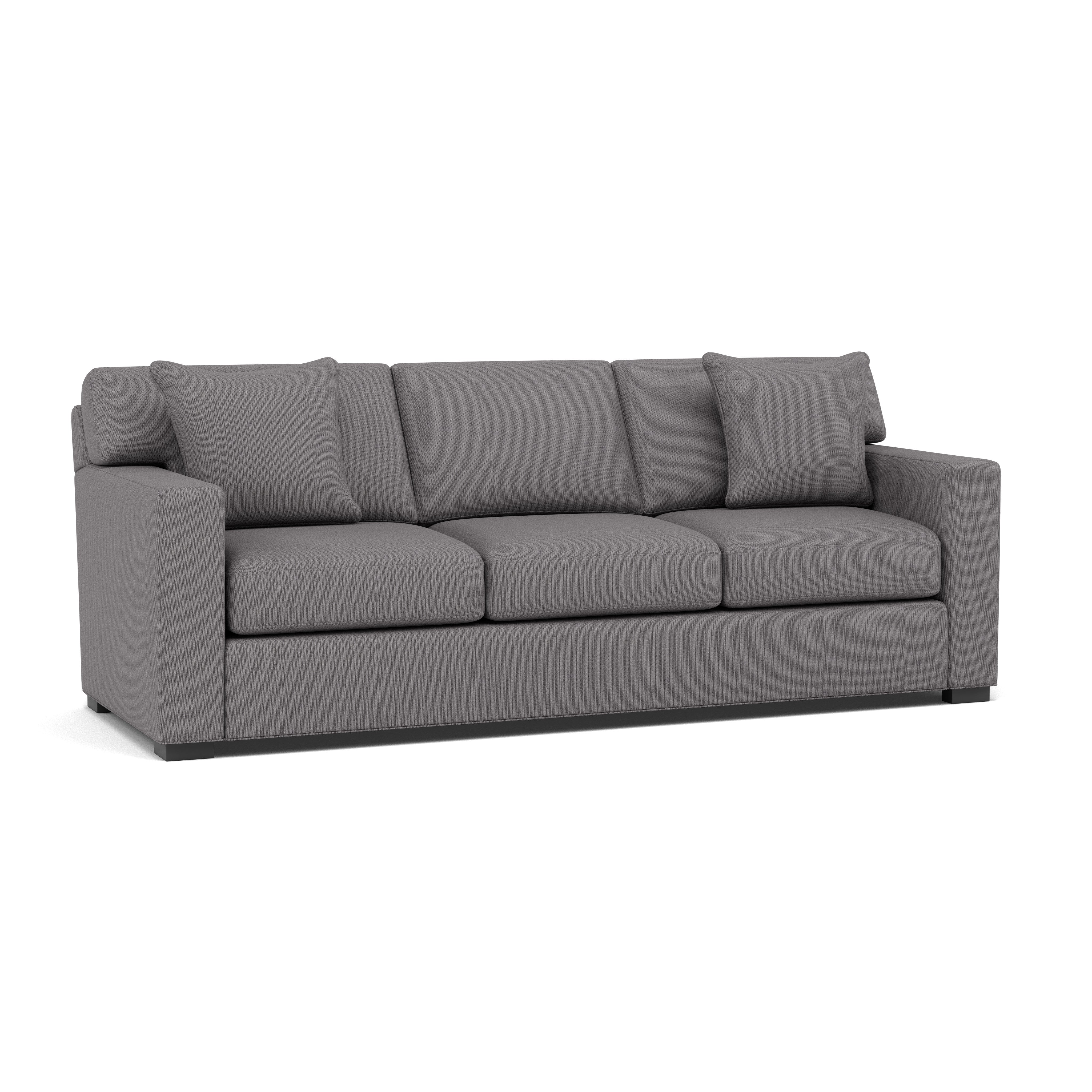 Modern gray sofa with three seat cushions and two matching pillows.