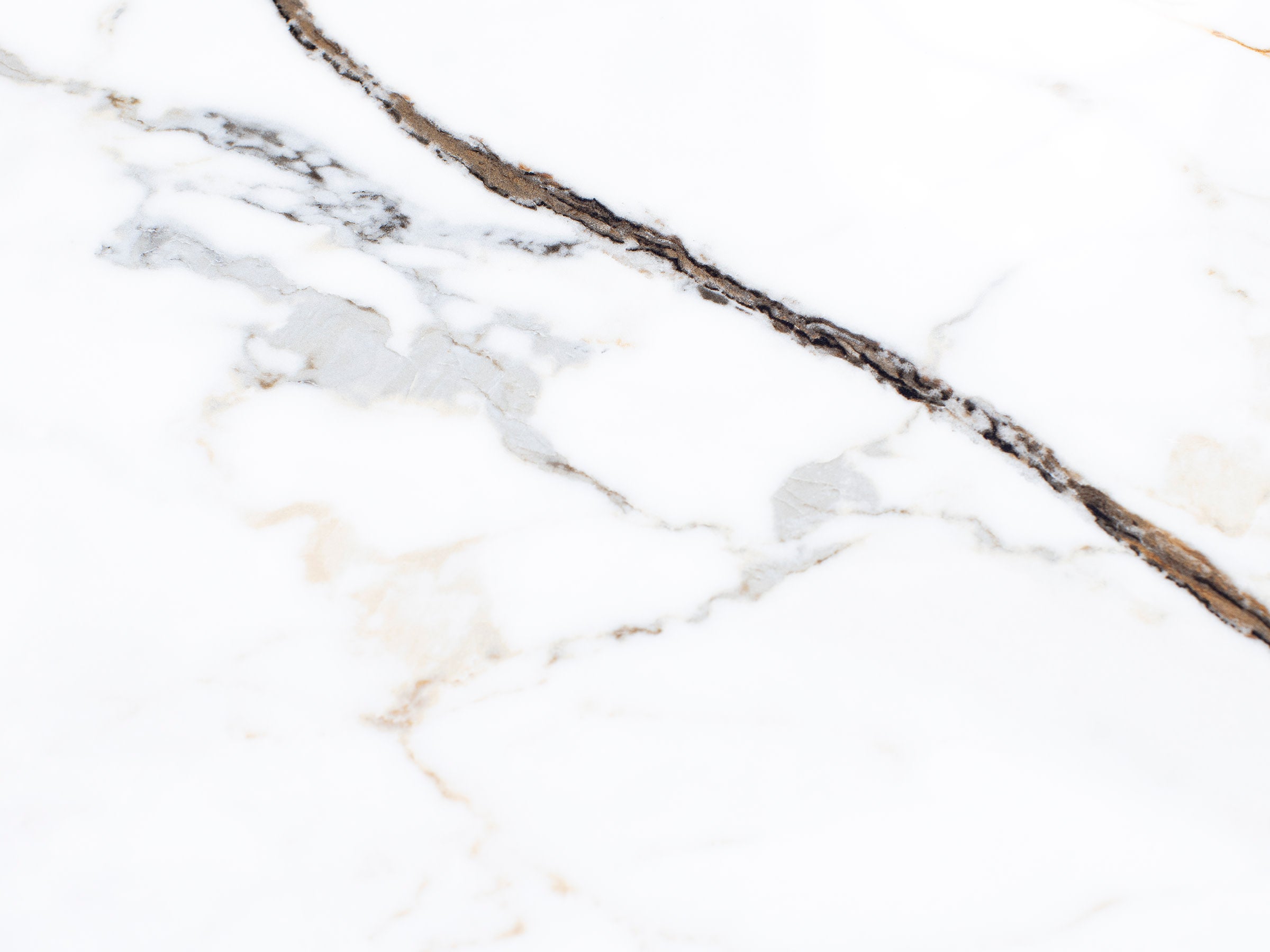 White marble surface with gray and brown veining.