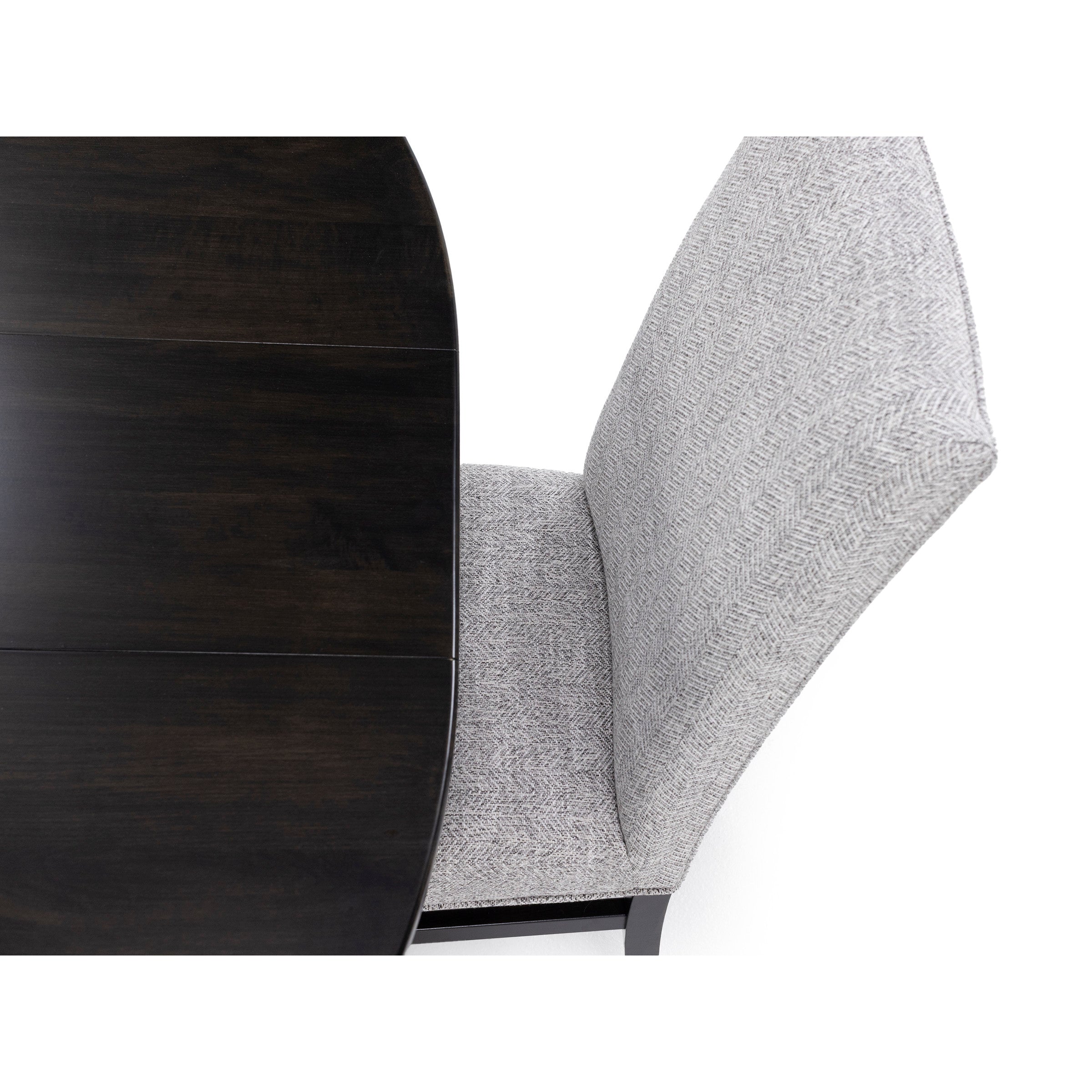 Dark wood tabletop with a light gray upholstered chair, viewed from above.
